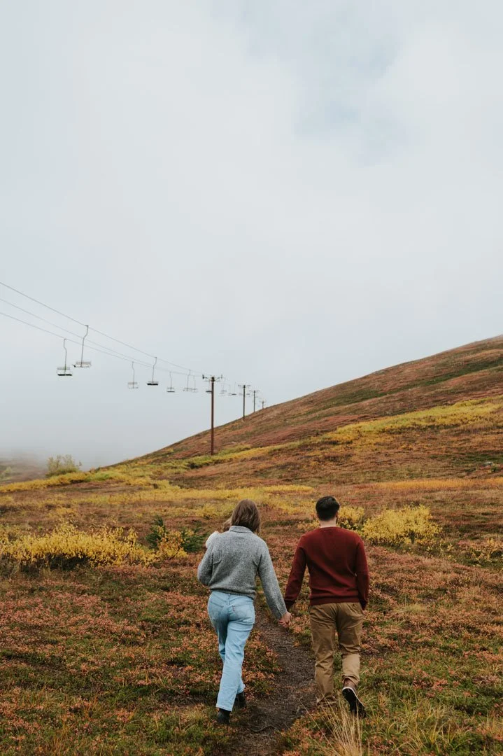 family walking together with young child towards chairlift on mountain 
