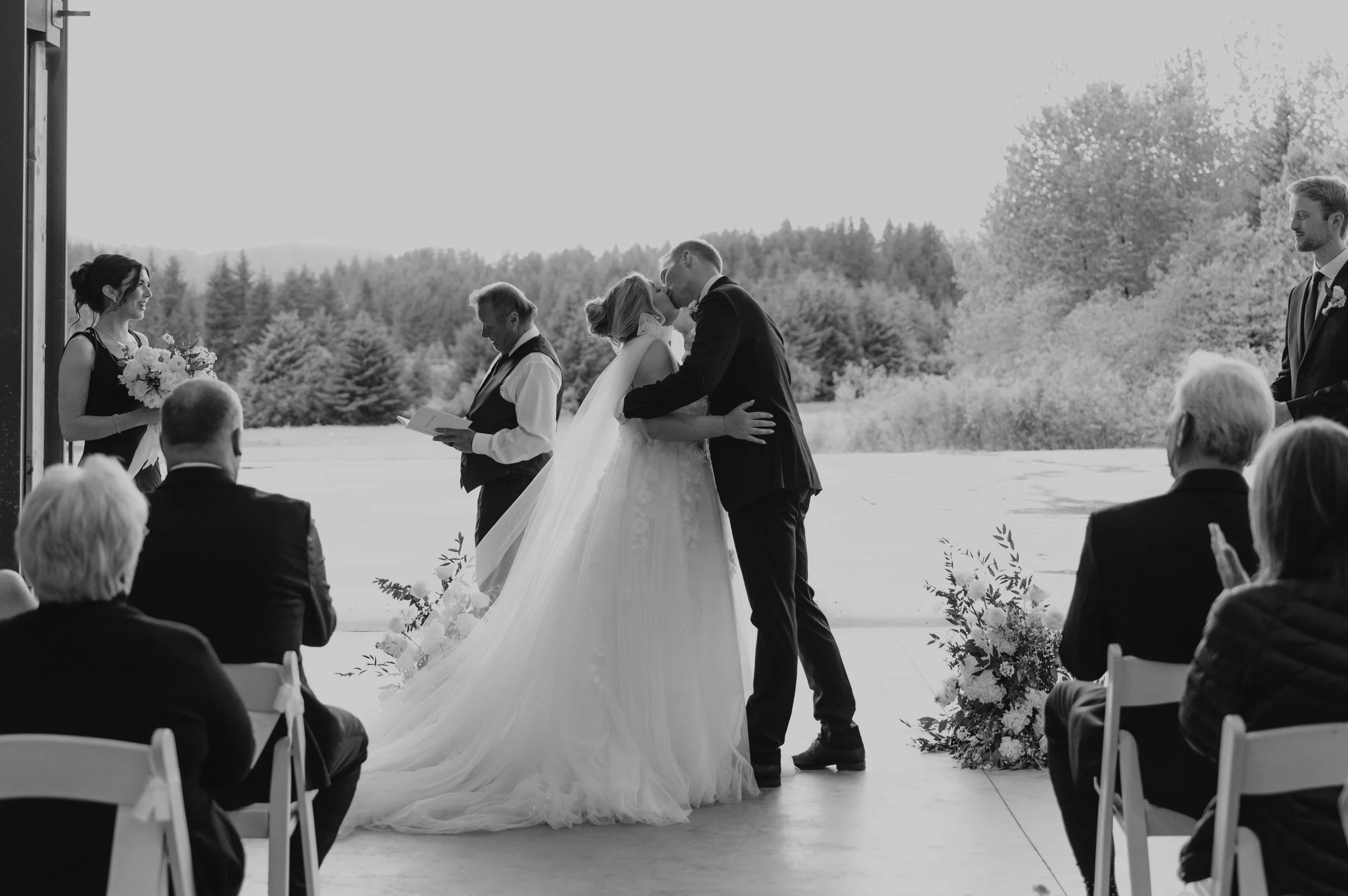 bride and groom kissing at aisle