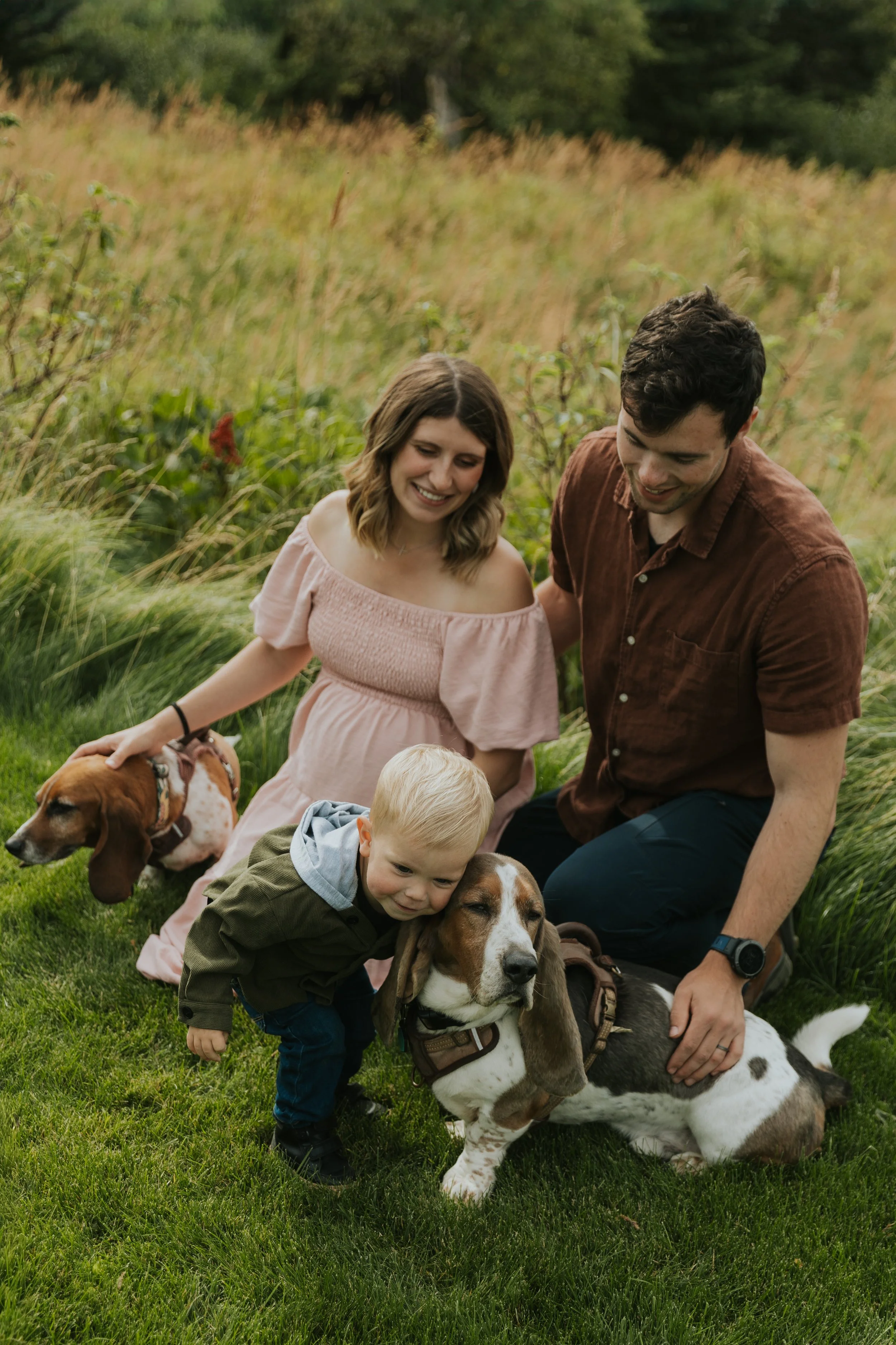 family photo of mazzy and two dogs, husband and toddler