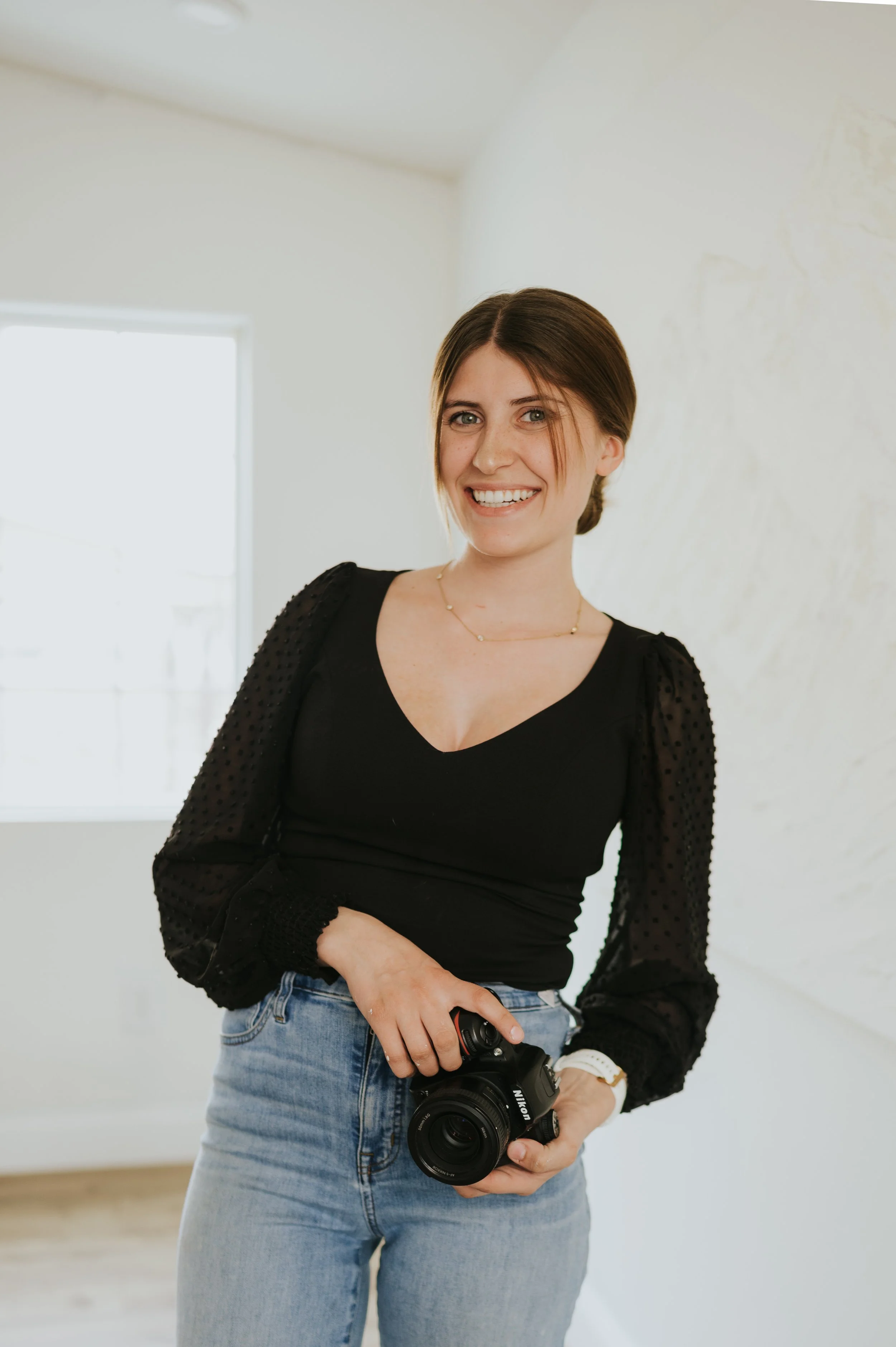 A picture of Mazzy holding camera and smiling at camera