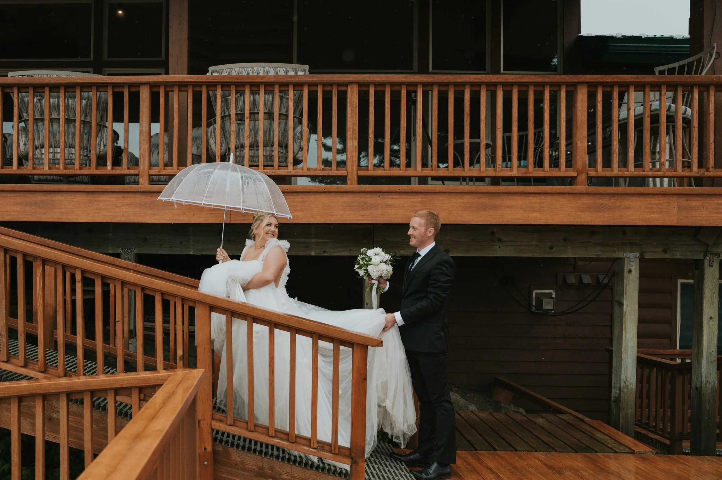 groom holding brides dress