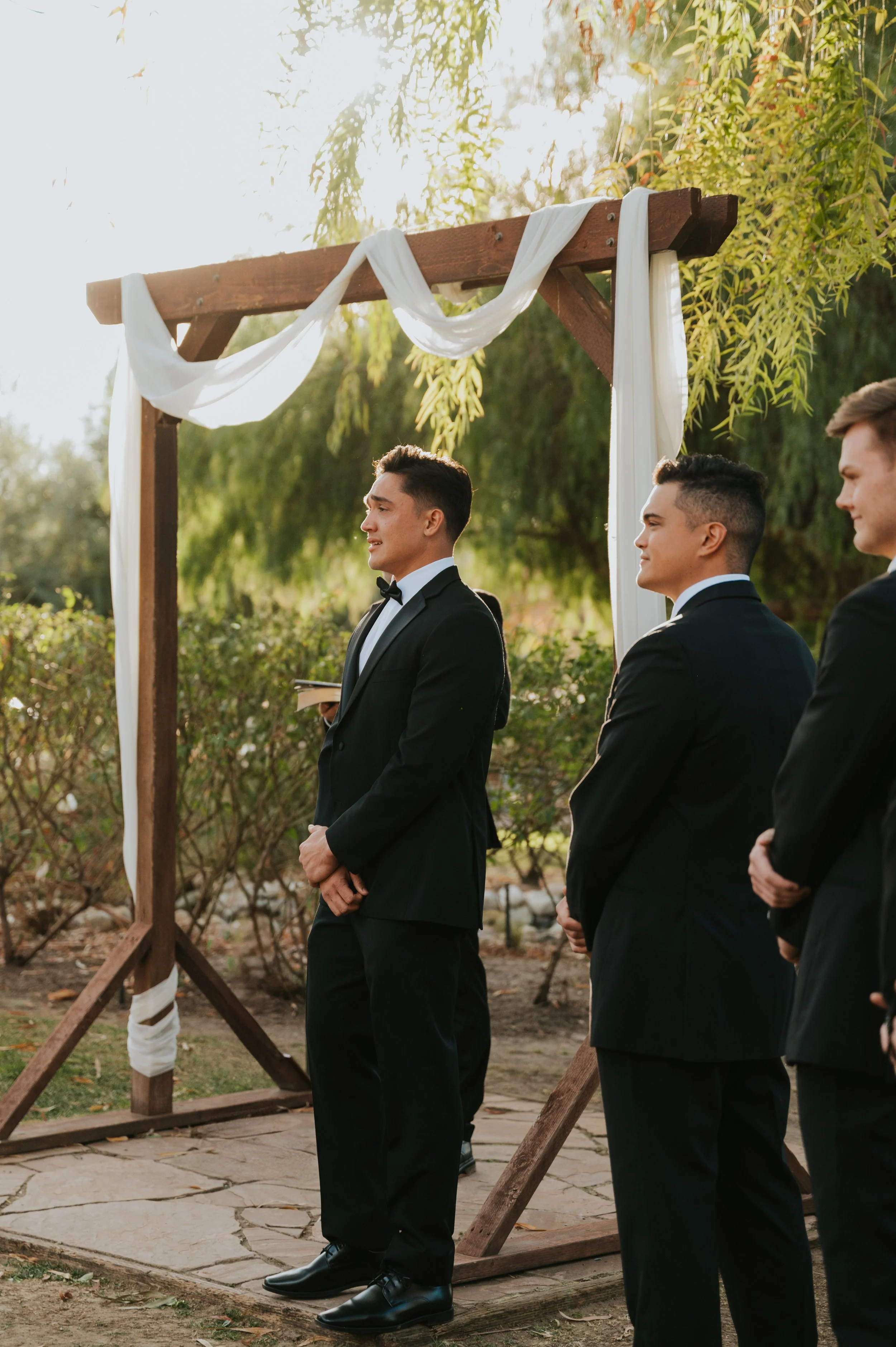 groom watching bride walk down aisle