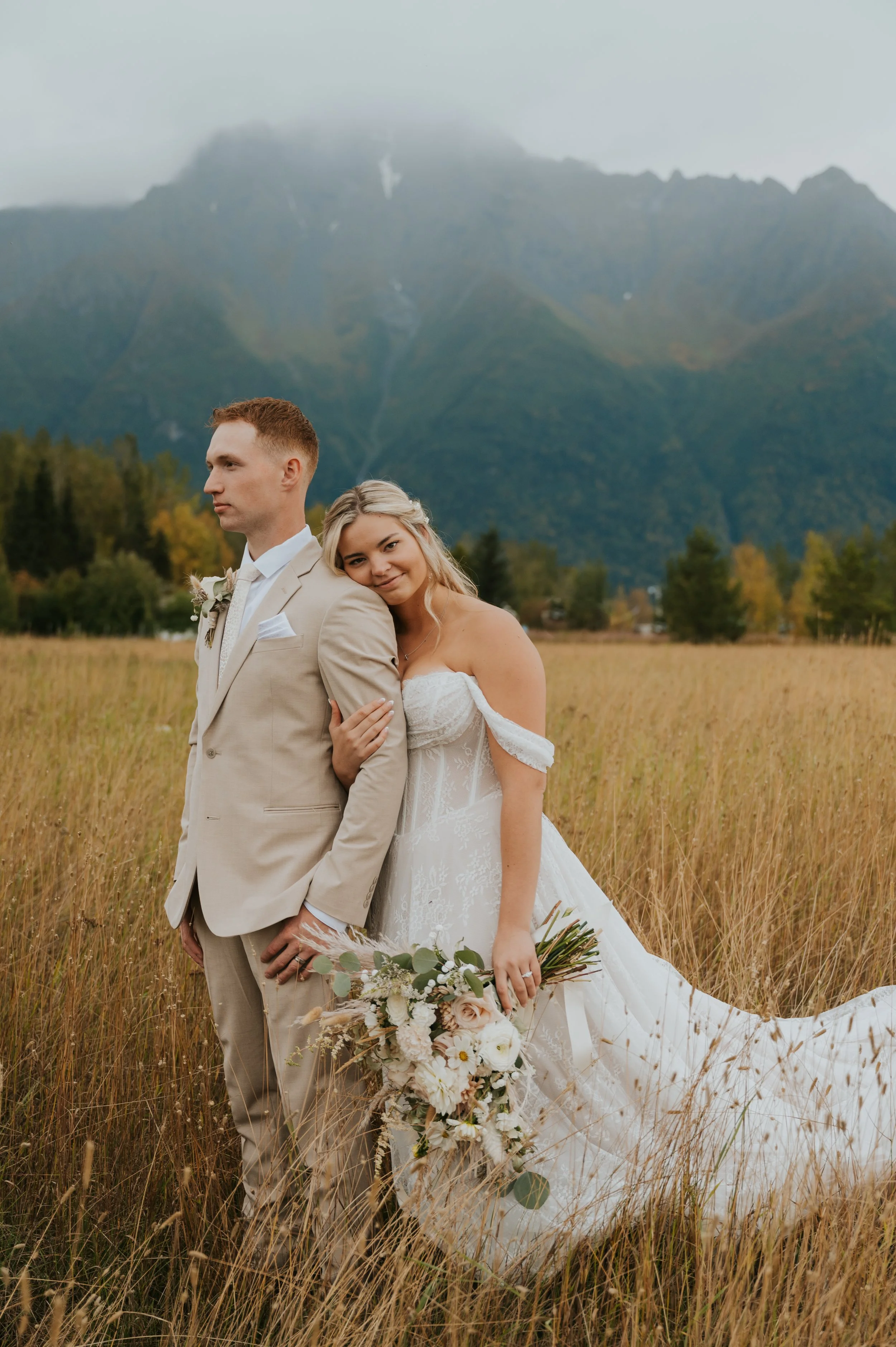 bride and groom in front of mountains