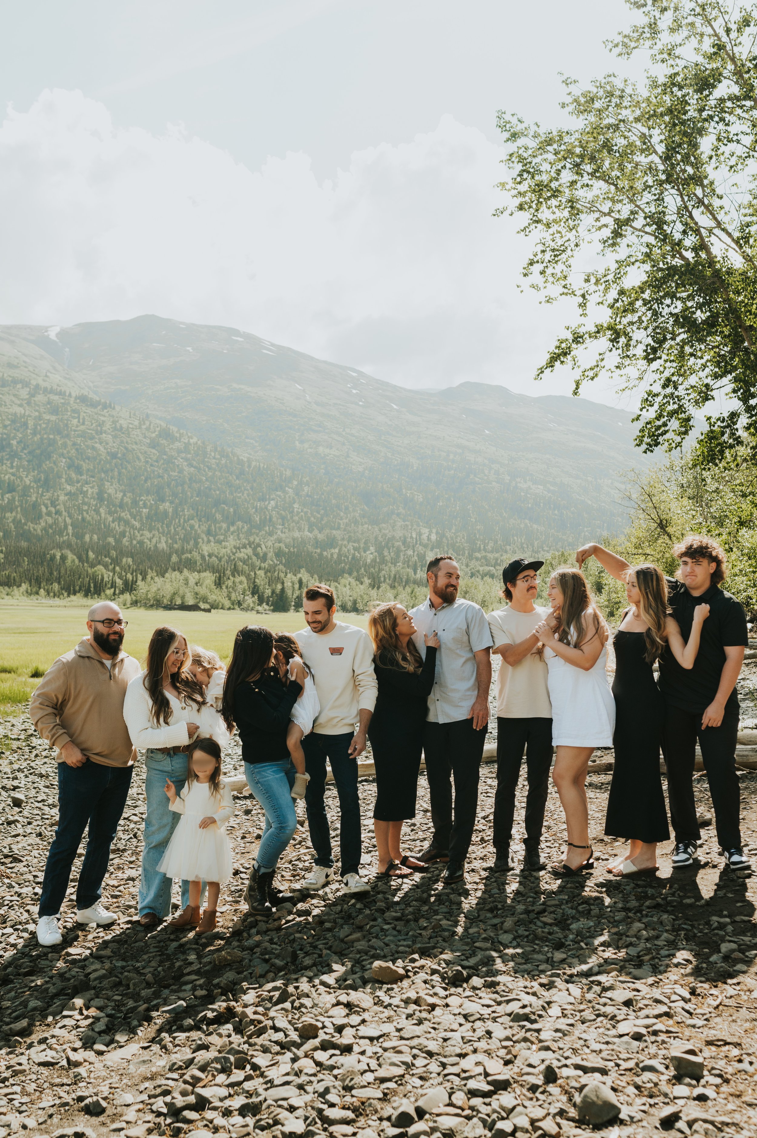 large family outside in mountain background