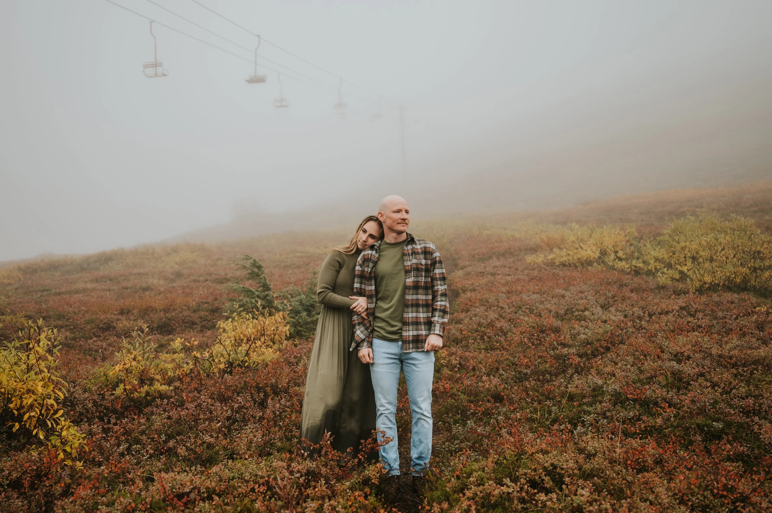 couple in fall setting on mountain standing side by side