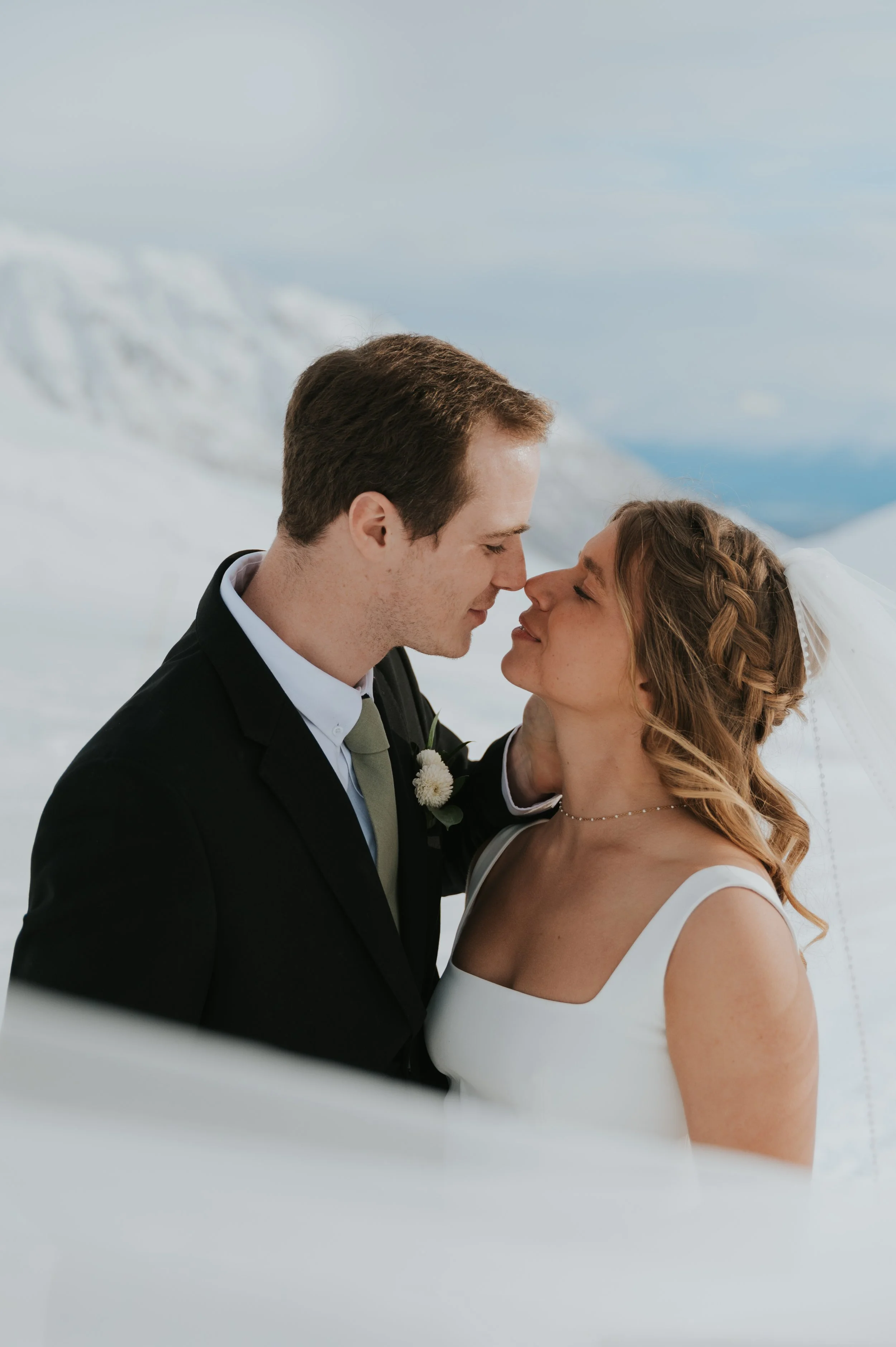 bride and groom in winter setting touching noses