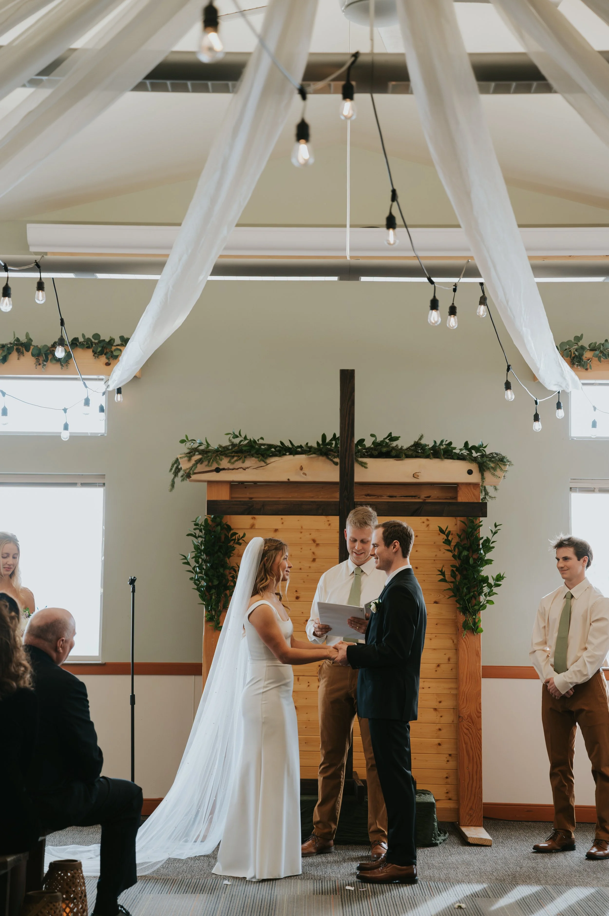 bride and groom holding hands at altar