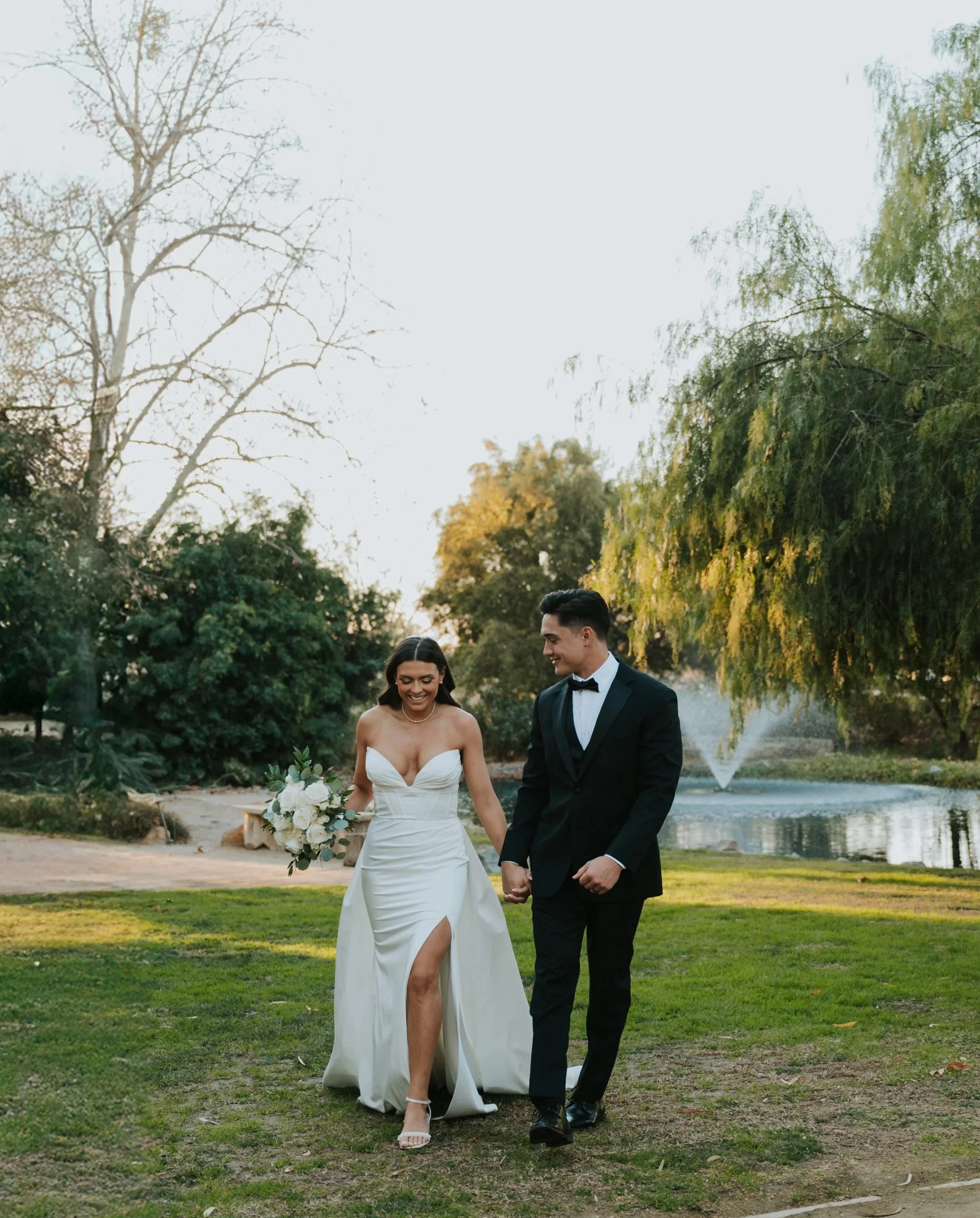 couple walking away from small lake