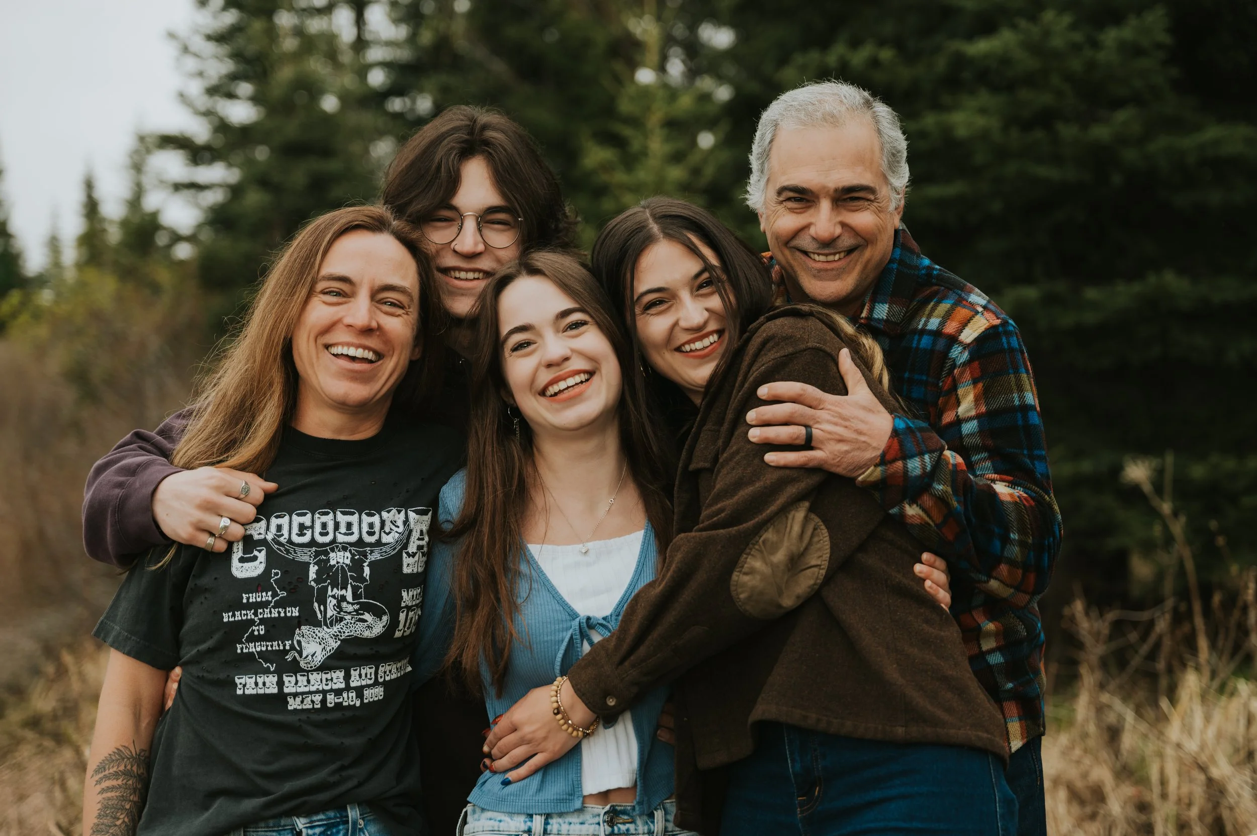 family with older children smiling at camera
