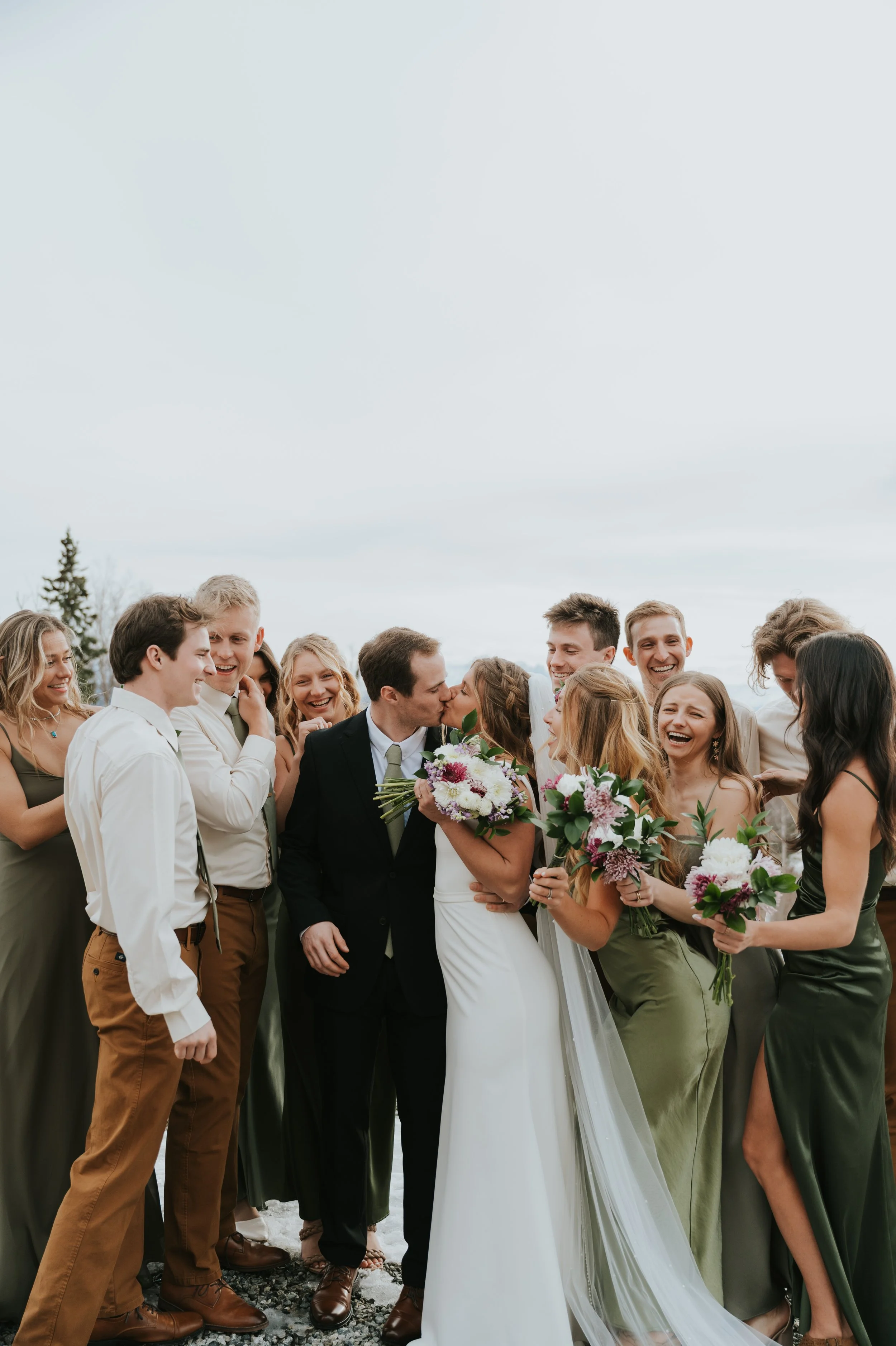 bride and groom in winter setting surrounded by bridal party