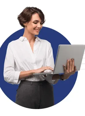 A woman smiling and looking at a laptop screen.