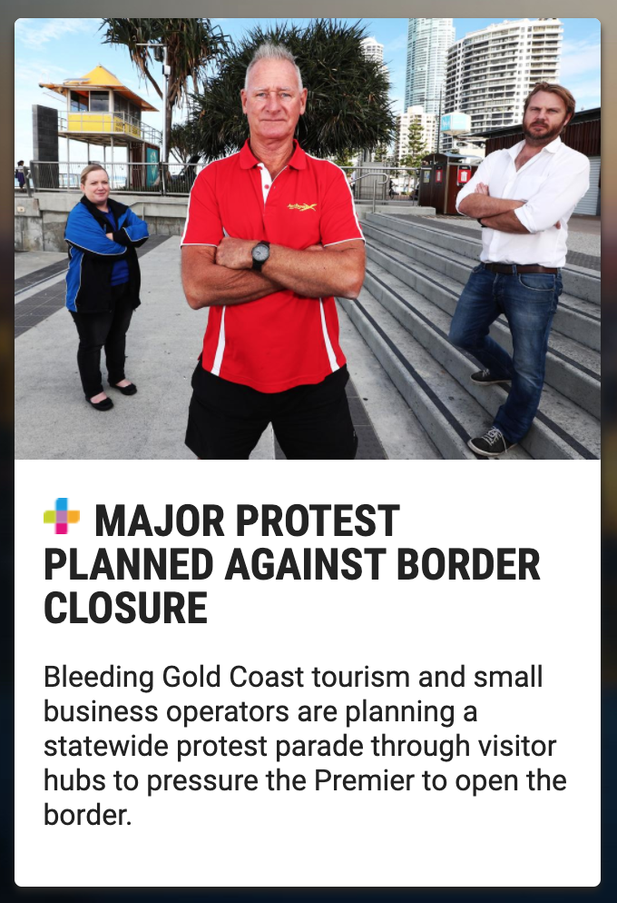Three individuals protesting against border closure in an urban area with tall buildings and palm trees in the background. The man in the foreground wears a red polo shirt, stands with arms crossed, and looks directly at the camera. A woman in a blue
