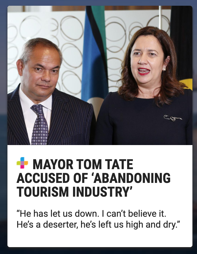 Photo of two people, a man in a pinstriped suit and a woman in a dark dress, speaking at a press conference with flags in the background.