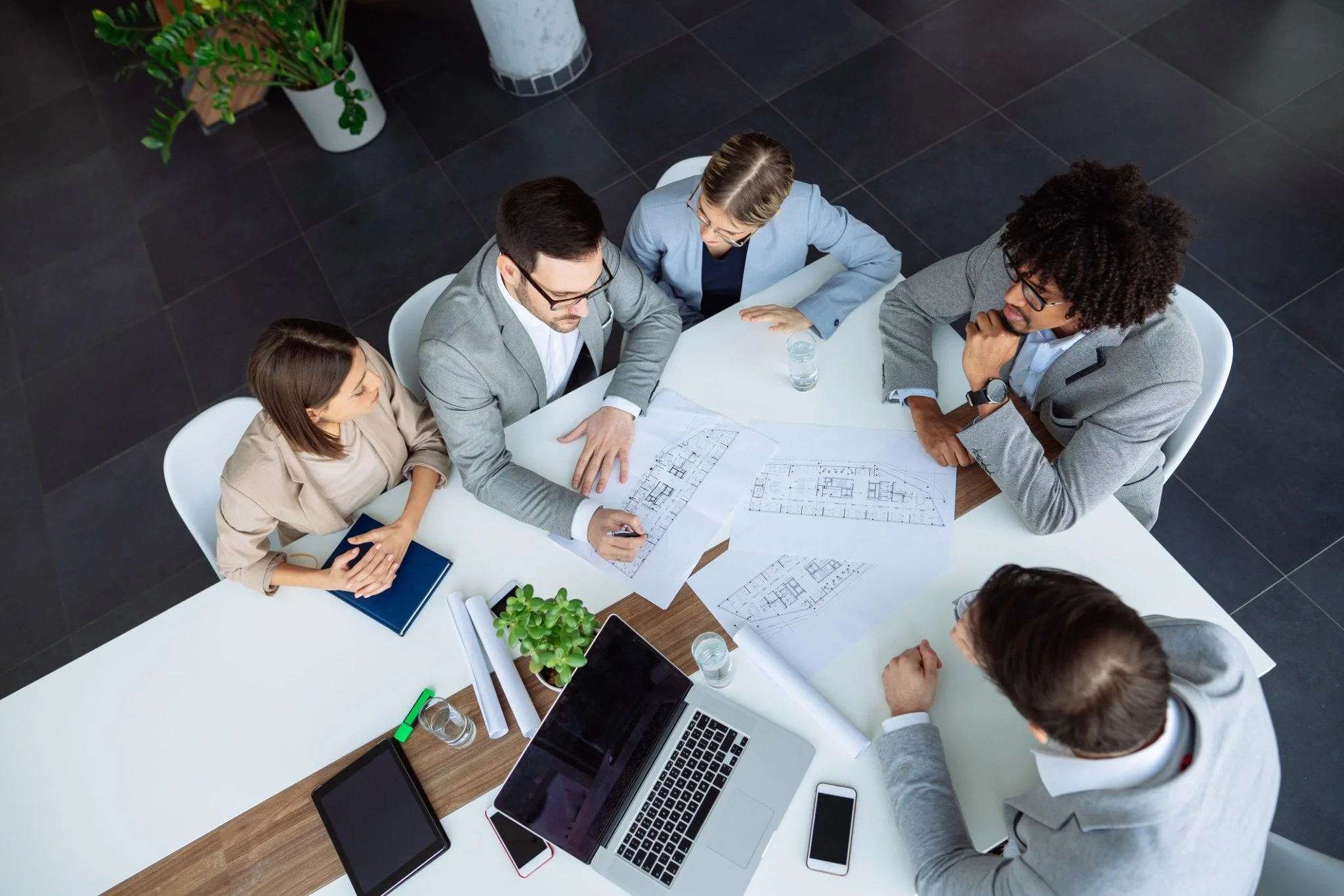 Sarah Colgate-Meeting-working-on-plans-in-board-room-scaled.jpg