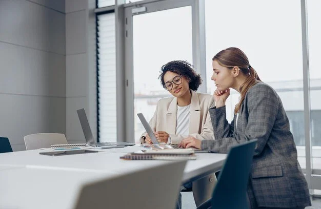 Sarah Colgate _two-focused-female-coworkers-working-project-together-use-laptop-sitting-office_386185-9159.jpg