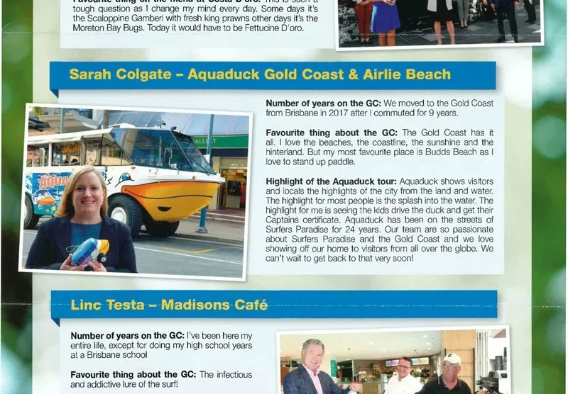 A woman with blonde hair smiling and holding a small toy while standing in front of a colorful aquabus on the street. A bus with a whale design and the words 'Aquabus' visible in the background.