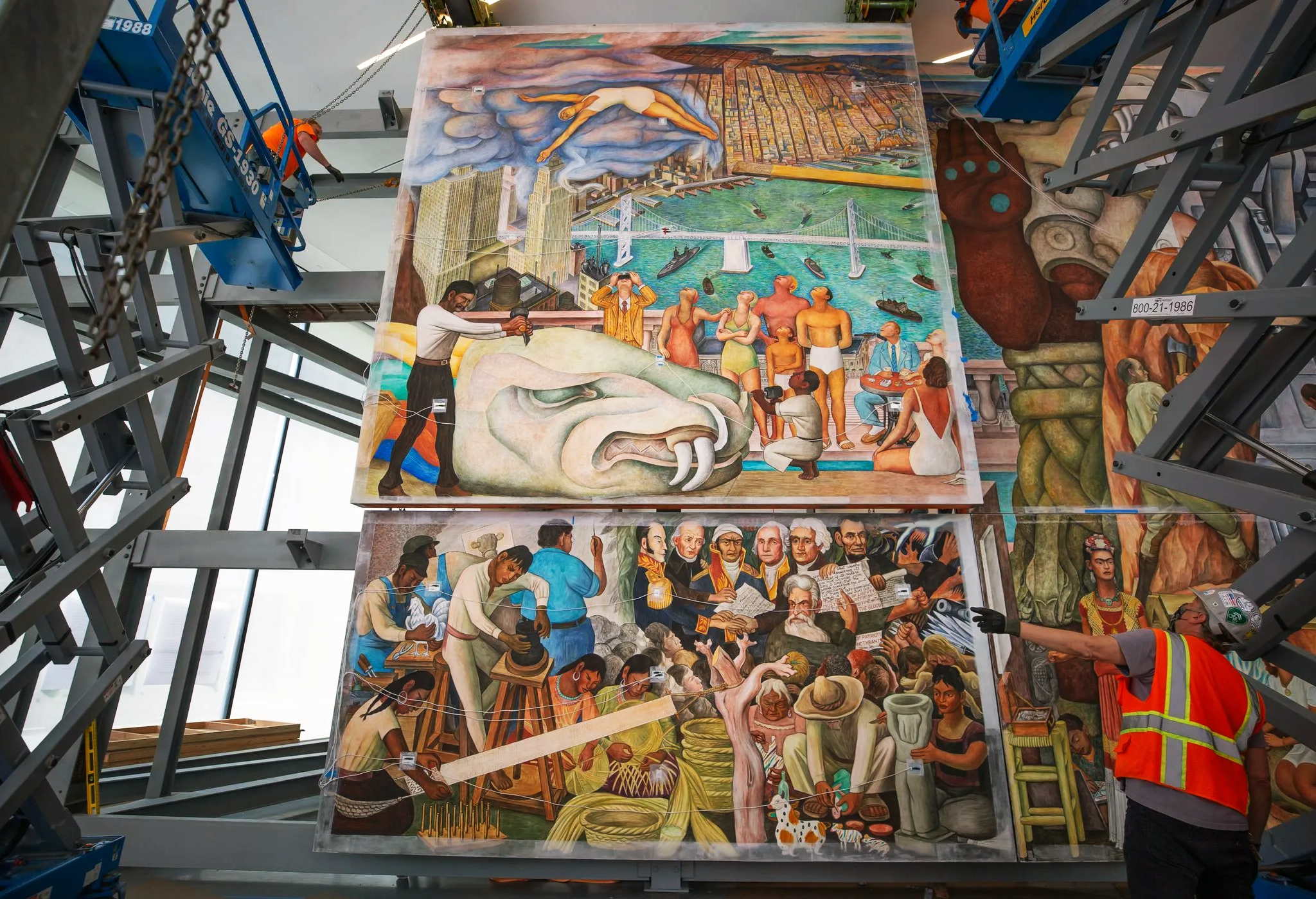 Construction site with a large red gantry crane, scaffolding, and industrial equipment.
