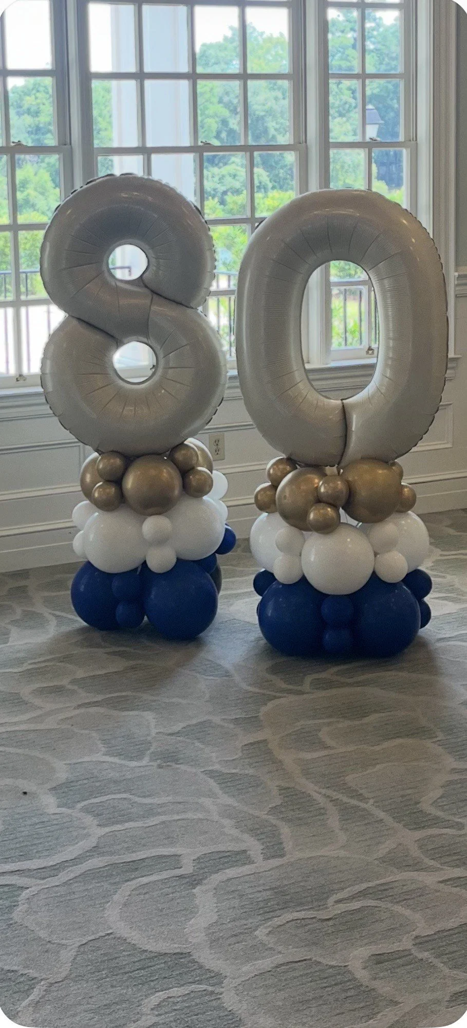 Balloon Number Stacks for an 80th Birthday in Blue, white and gold balloons with cream colored number mylar balloons