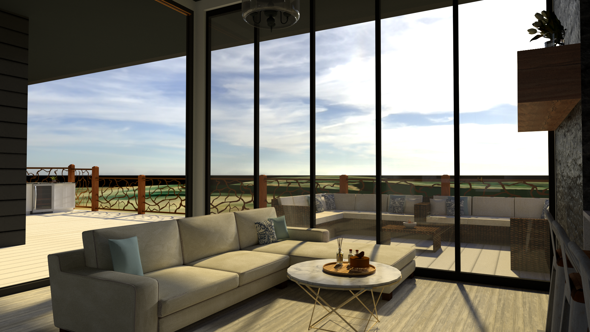 Interior of a modern living room with a beige sectional sofa, throw pillows, a double coffee table, and a glass wall opening to a balcony with outdoor seating and a scenic view of a grassy landscape.