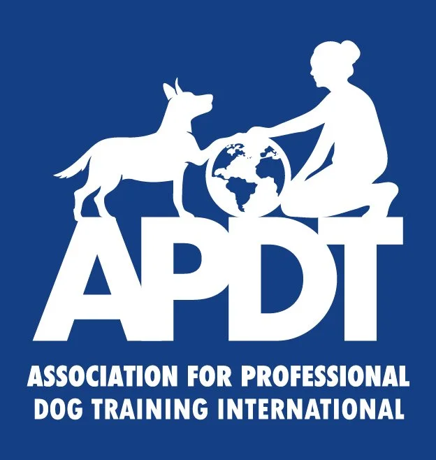 Logo of the Association for Professional Dog Training International with a silhouette of a woman and a dog reaching towards a globe.
