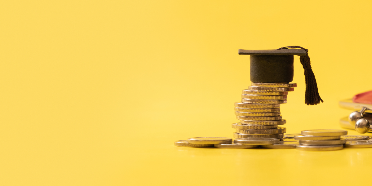 Stack of coins with a graduation cap on top, against a yellow background.