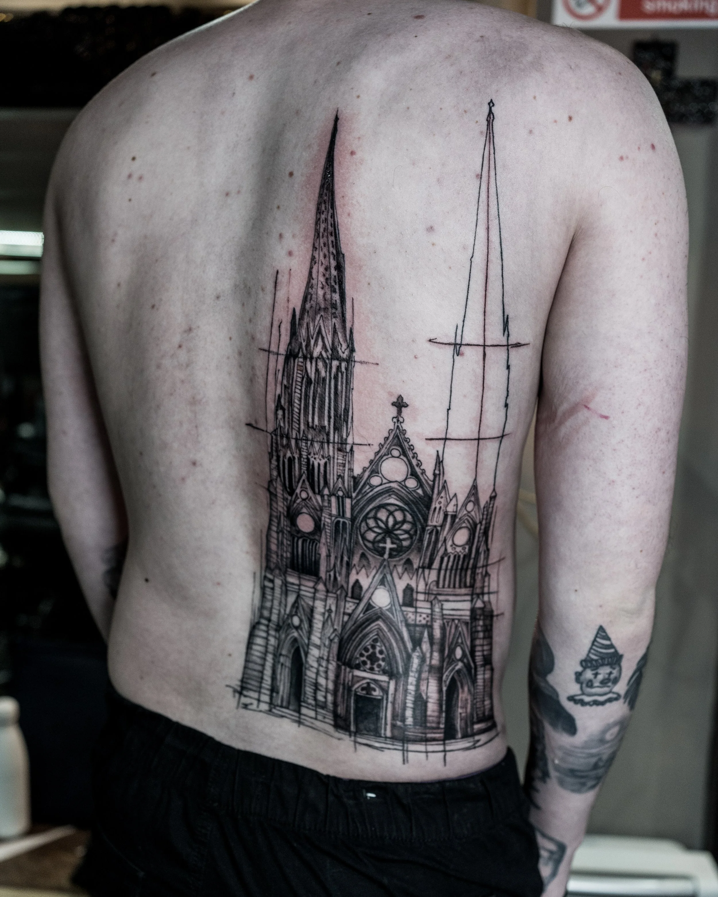 Large black and grey back tattoo of a gothic church with detailed spires by Jay C Tattoo, Brighton tattoo artist, UK
