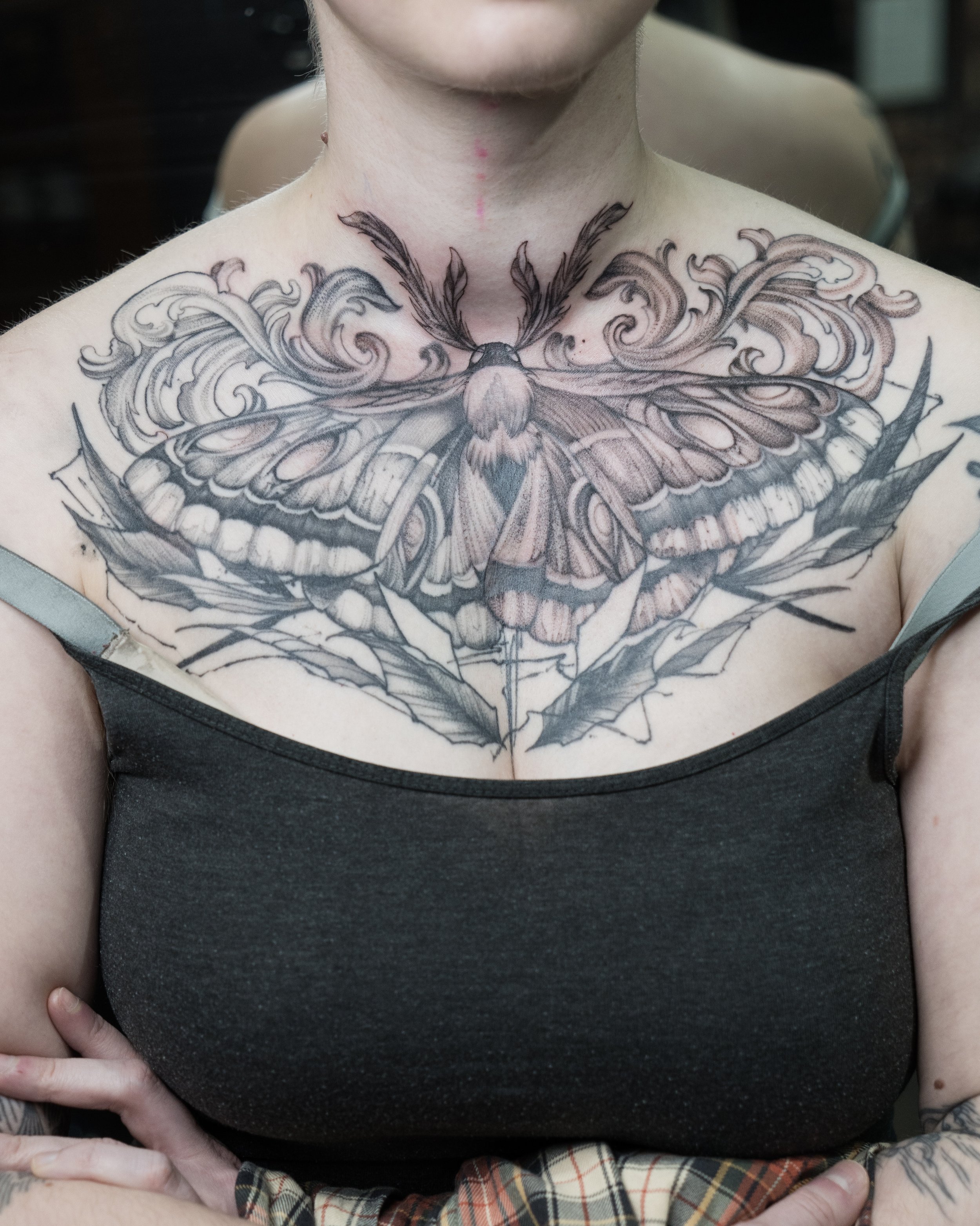 Black and grey tattoo of a large detailed moth on upper chest by Jay C Tattoo, Brighton and Hove tattoo artist, UK
