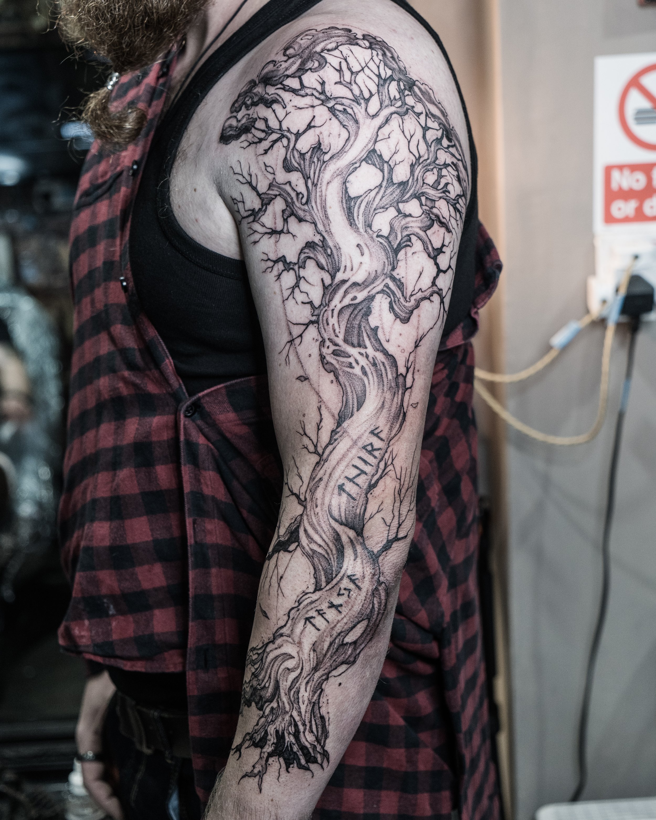 Black ink tattoo of a tree with branching limbs on upper arm and shoulder by Jay C Tattoo, Brighton tattoo artist, UK
