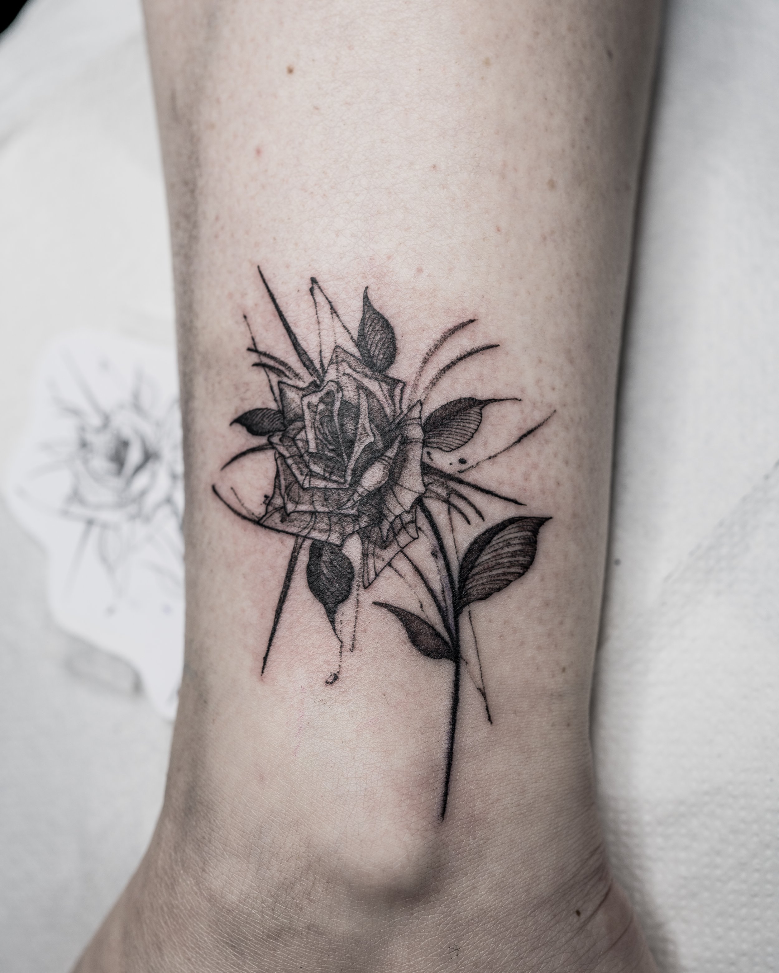 Black and grey realistic mini rose tattoo on ankle by Jay C Tattoo, Brighton tattoo artist, UK
