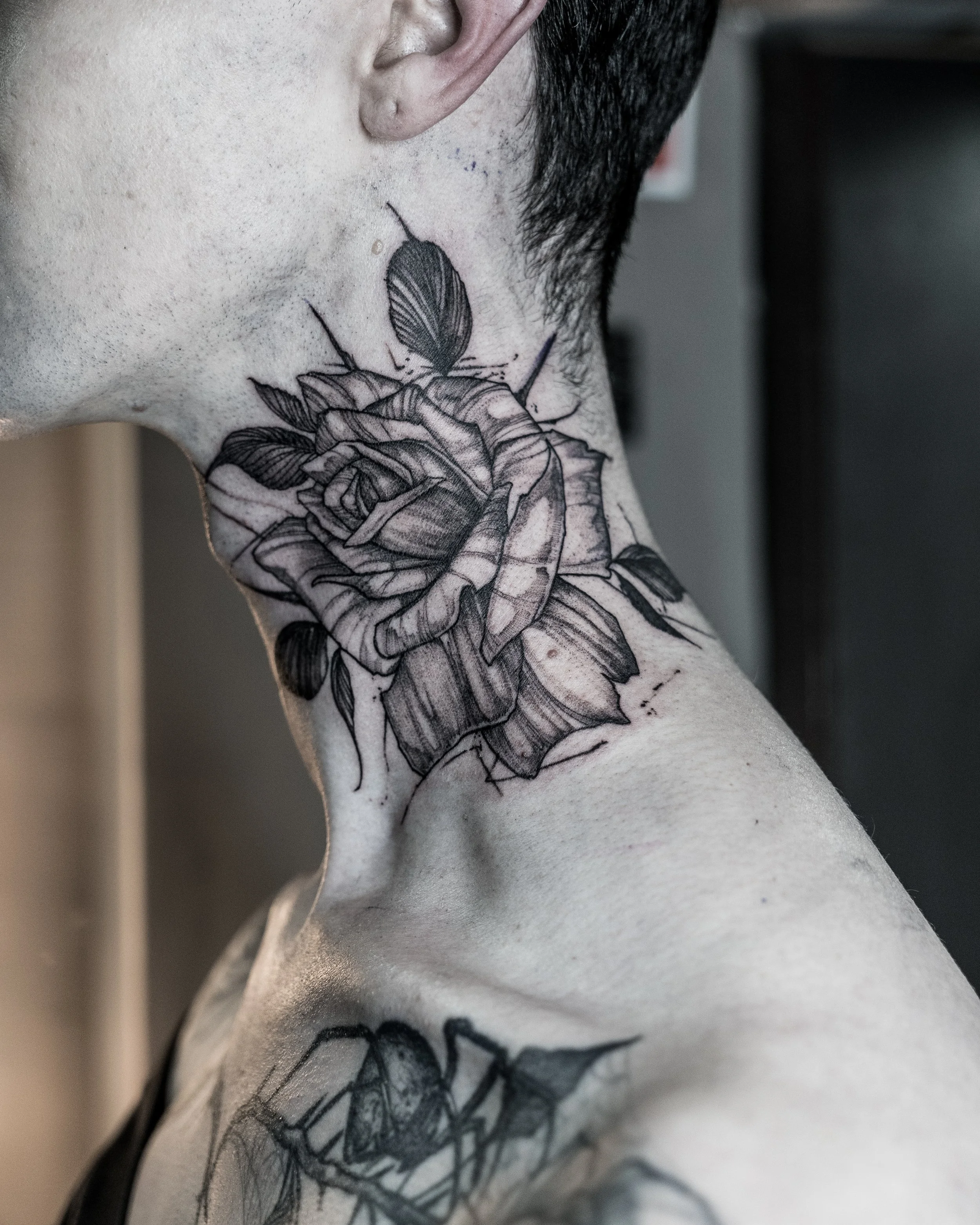 Black ink neck tattoo featuring a rose by Jay C Tattoo, Brighton and Hove tattoo artist, UK
