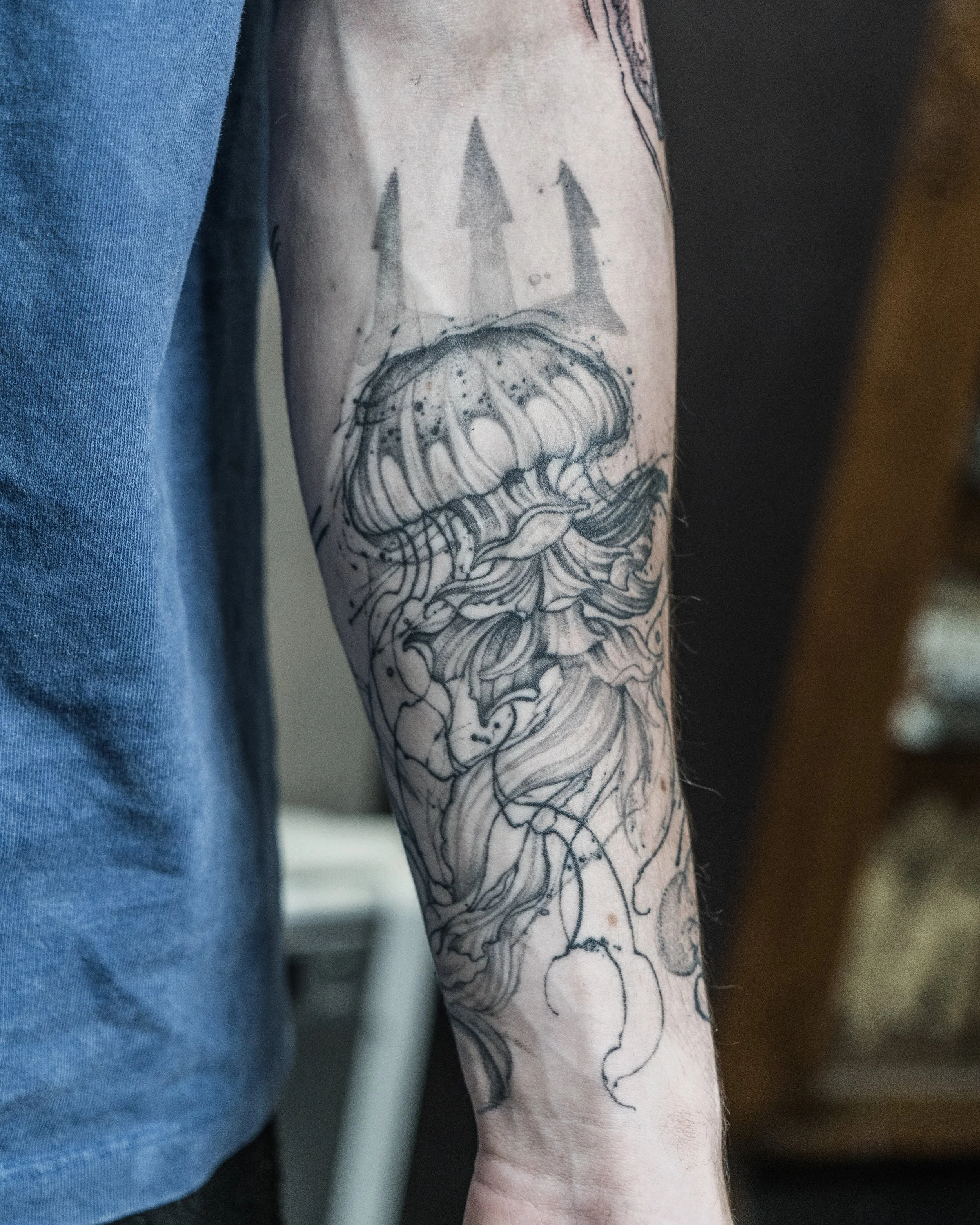 Black and grey jellyfish tattoo with trident on forearm by Jay C Tattoo, Brighton and Hove tattoo artist, UK
