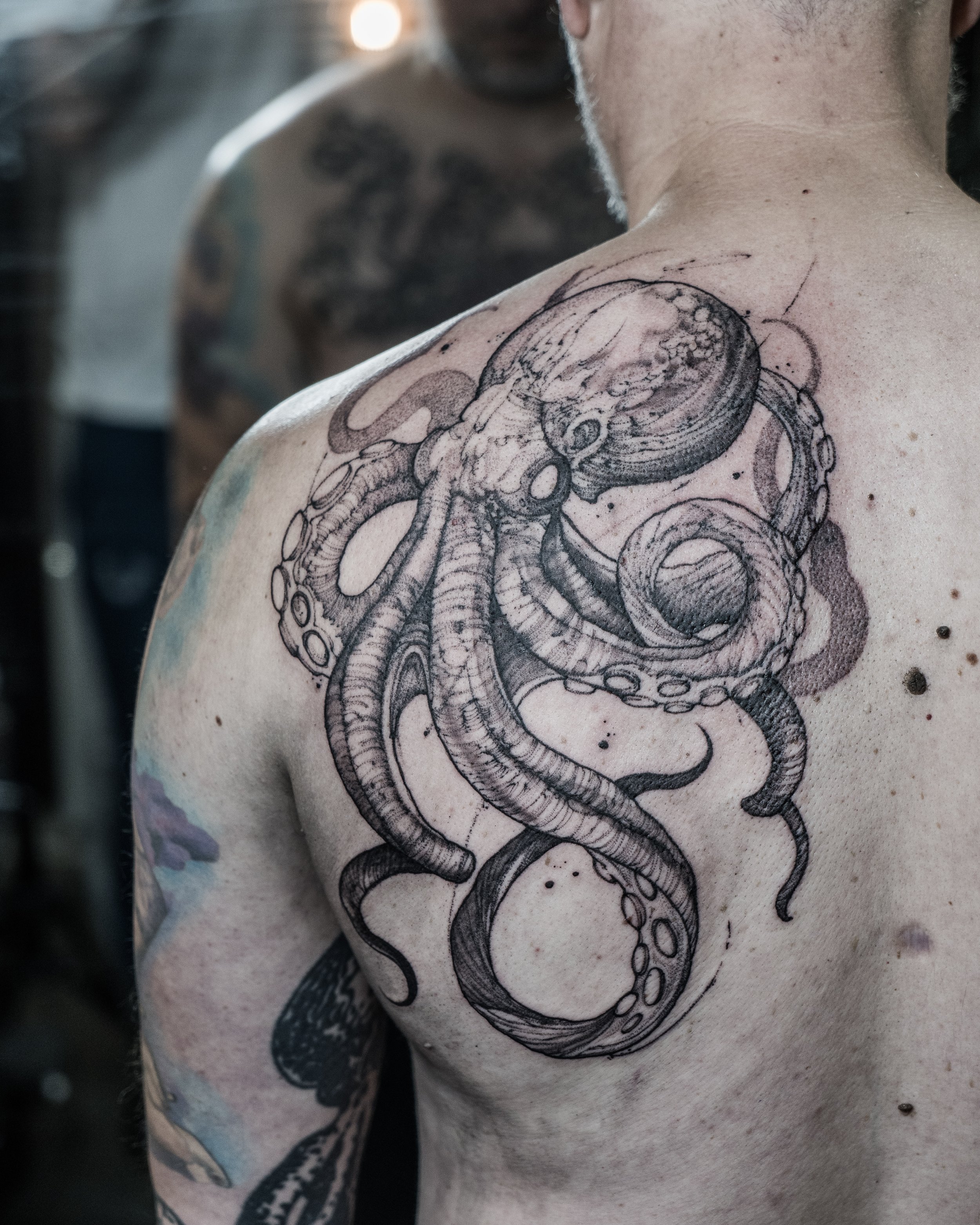 Large black and grey octopus tattoo on shoulder and upper arm by Jay C Tattoo, Brighton and Hove tattoo artist, UK
