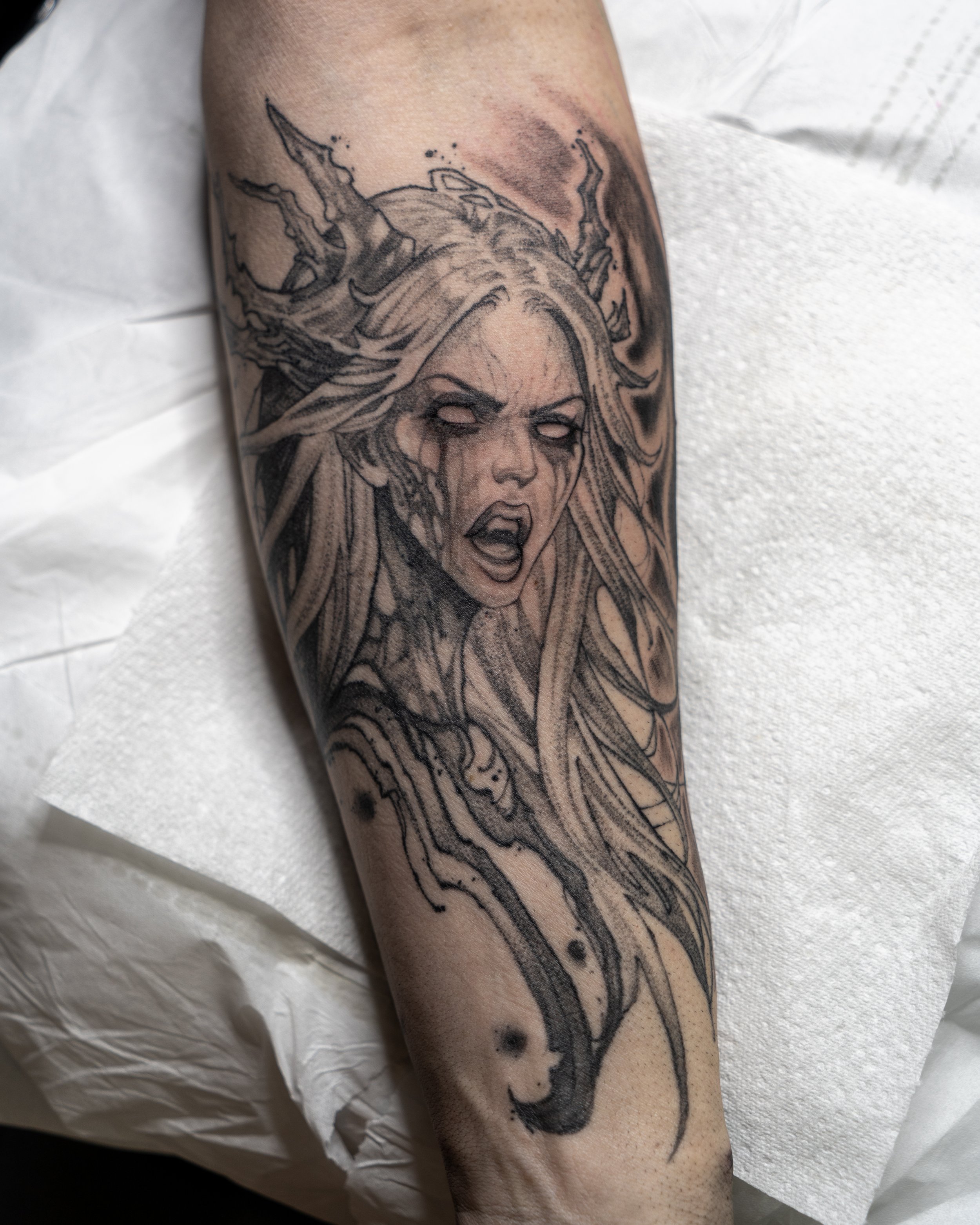 Black and grey tattoo of a fierce Banshee woman with long hair and horns by Jay C Tattoo, Brighton and Hove tattoo artist, UK
