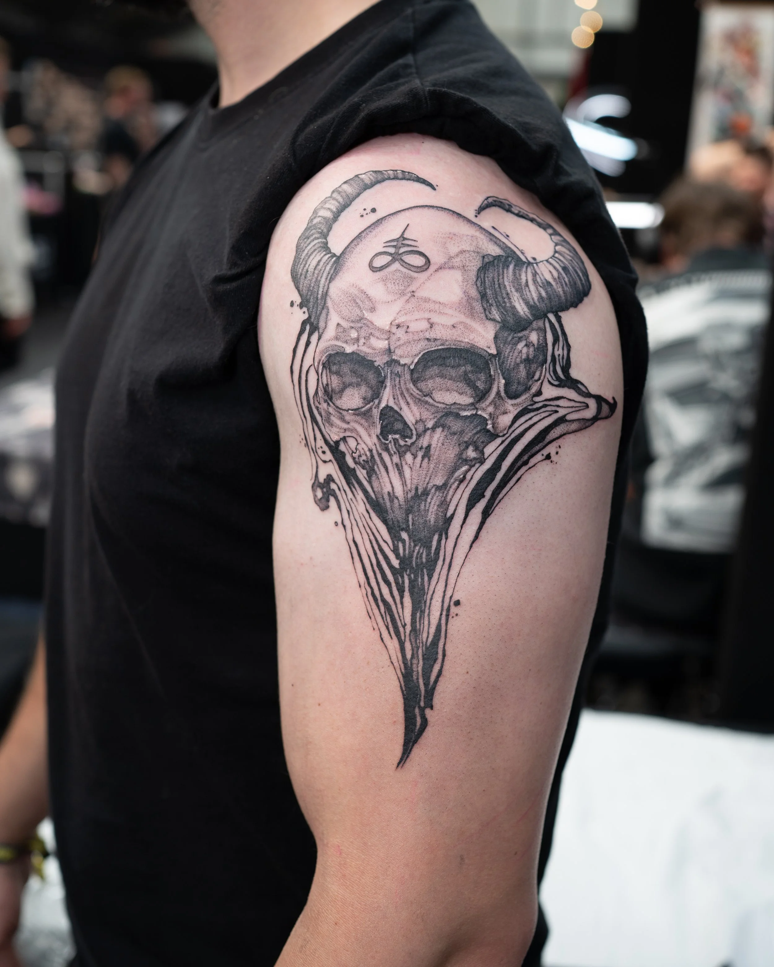 Black and grey tattoo of a skull with horns and flowing smoke effect by Jay C Tattoo, Brighton and Hove tattoo artist, UK
