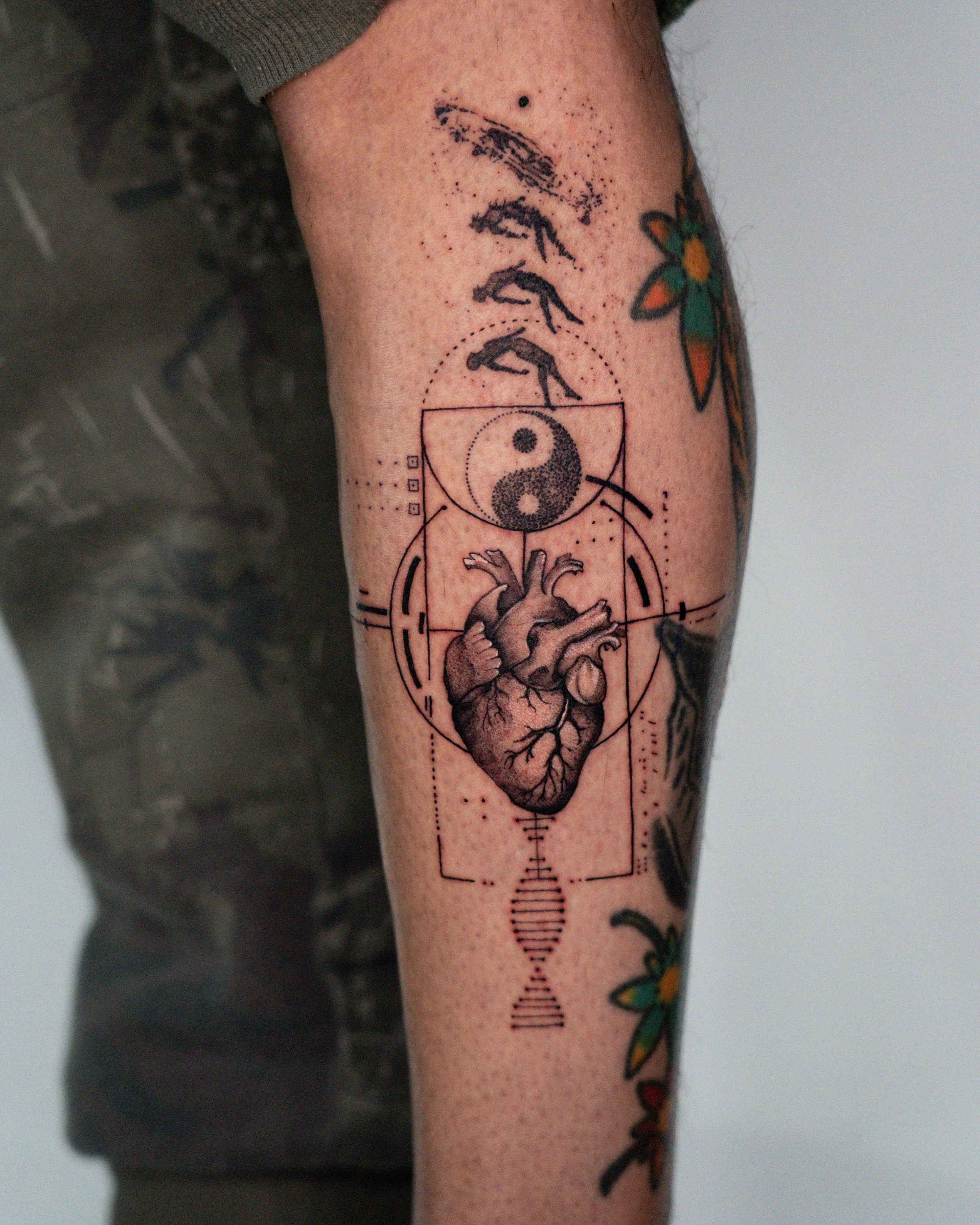 Black and grey fine line tattoo of a human heart with yin yang symbol and geometric elements by Jay C Tattoo, Brighton and Hove tattoo artist, UK
