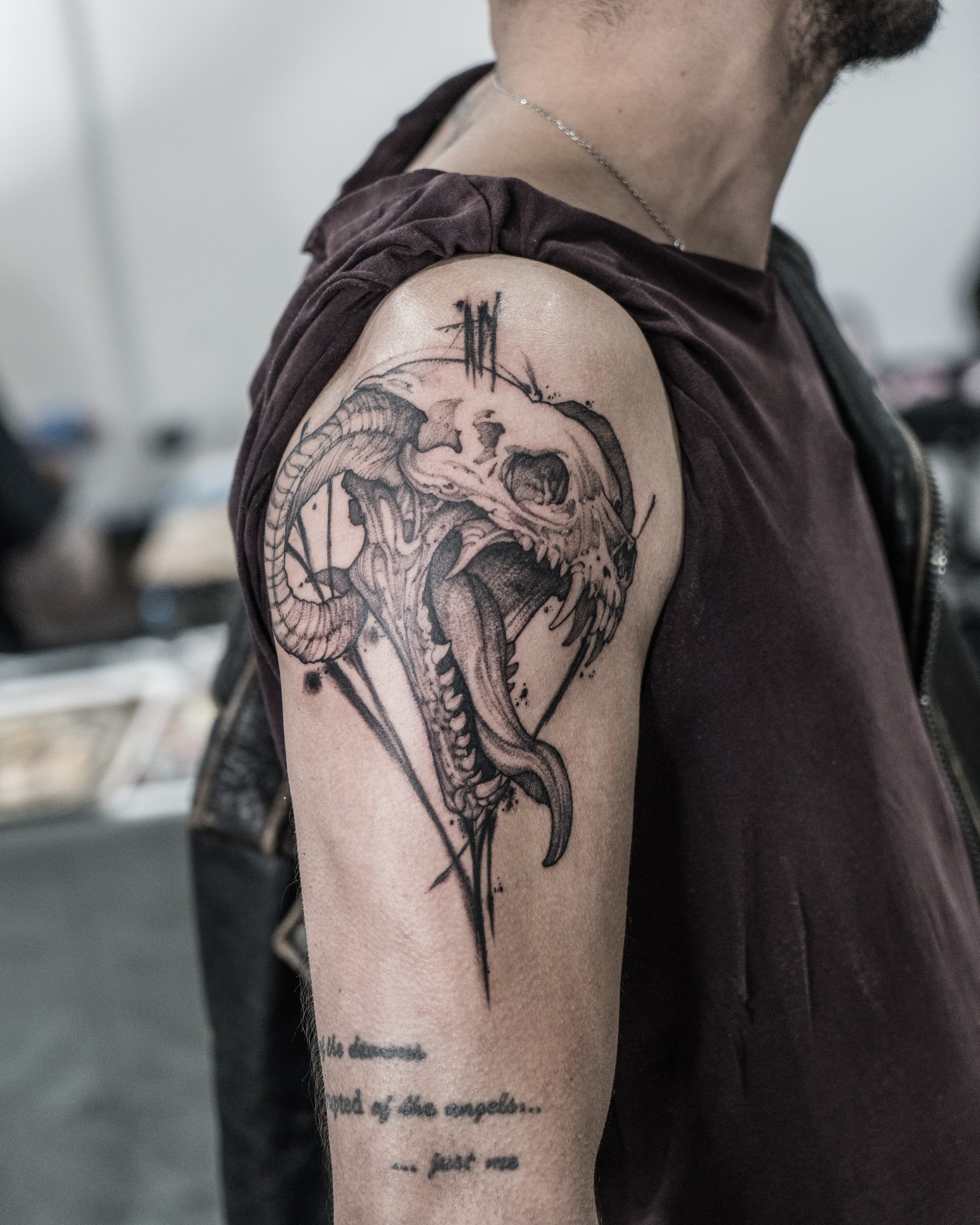 Black and grey Chimera skull tattoo with open mouth on upper arm by Jay C Tattoo, Brighton tattoo artist, UK
