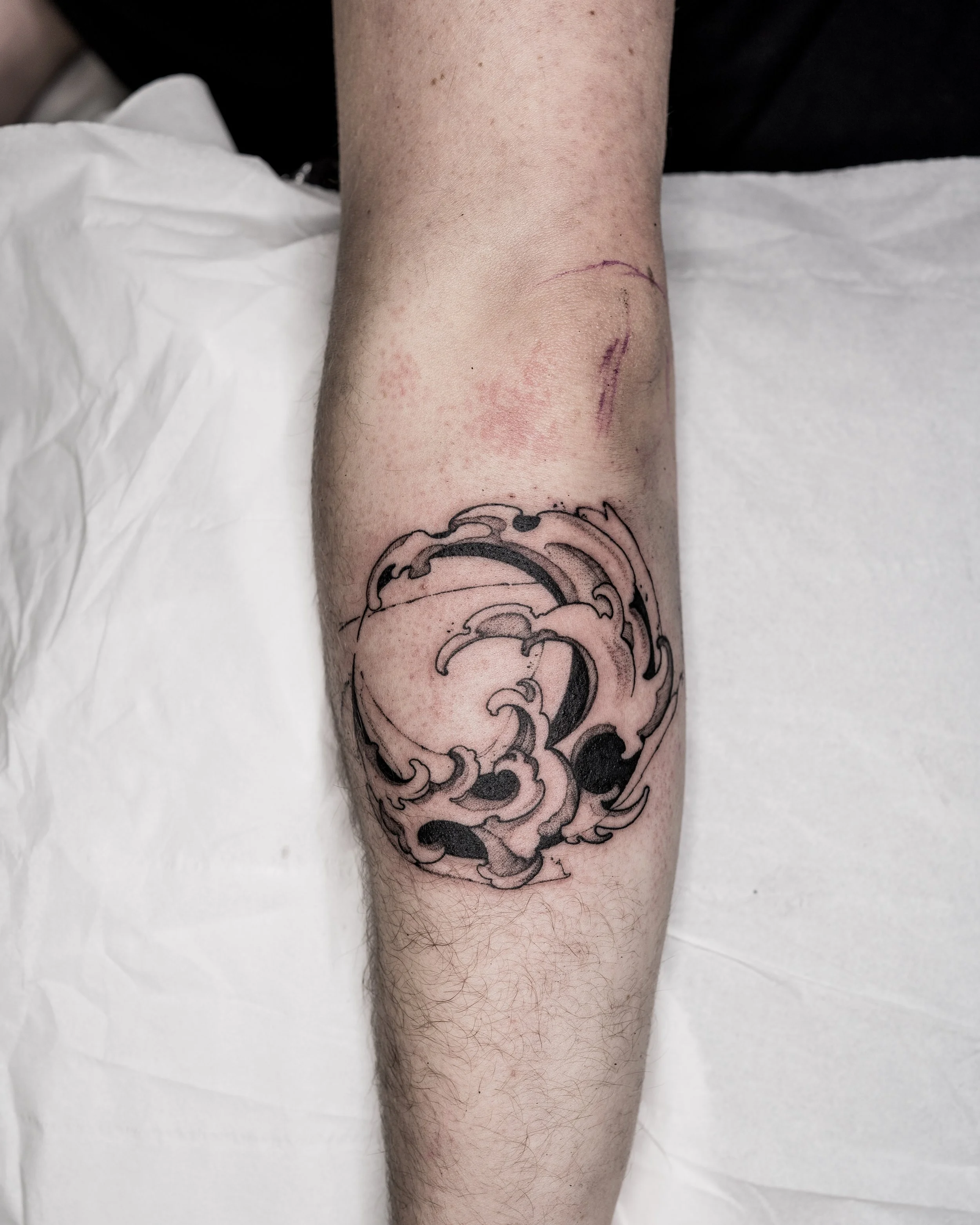 Fine line abstract wave tattoo on lower leg by Jay C Tattoo, Brighton and Hove tattoo artist, UK
