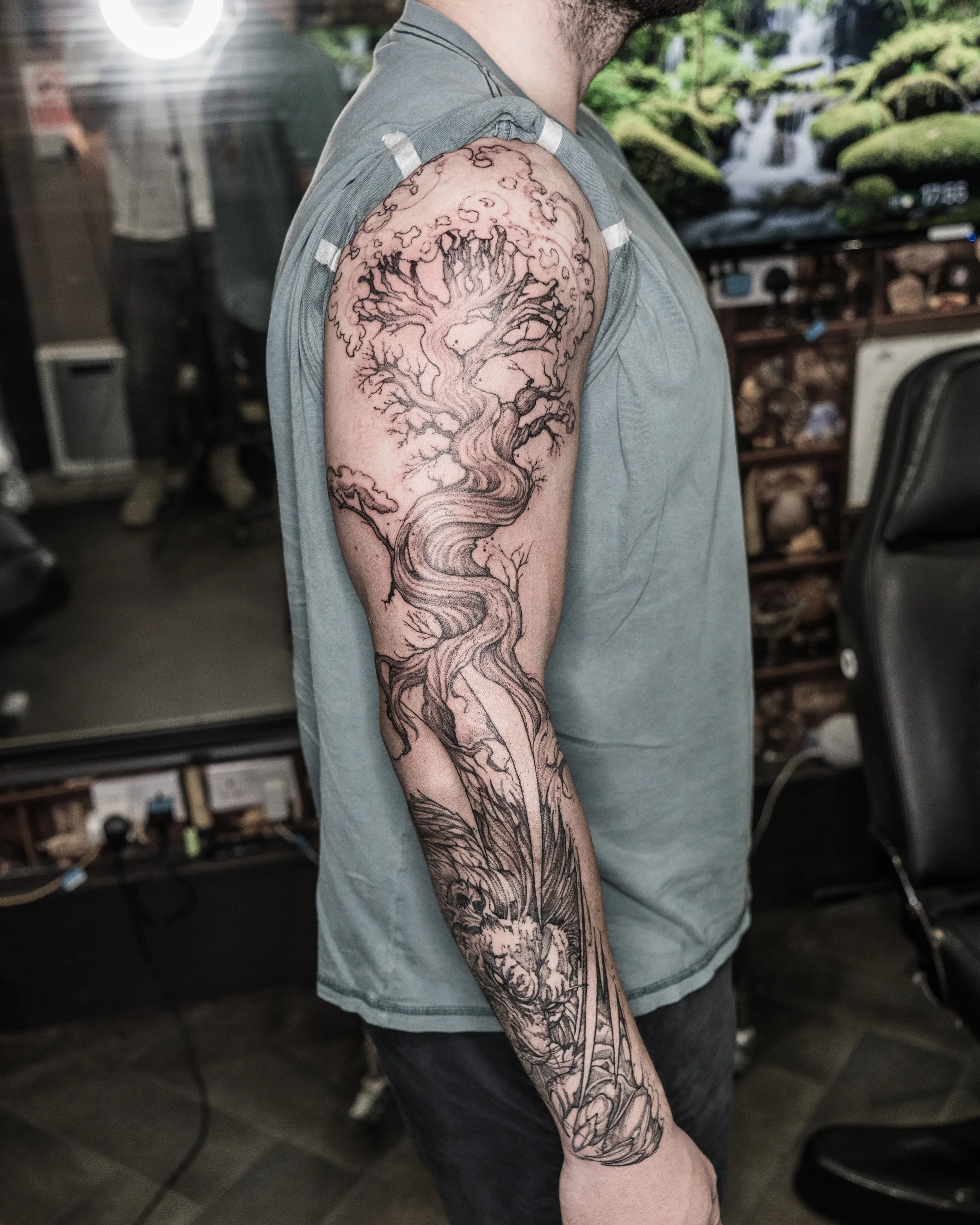 Black and grey tattoo of a stylised tree with flowing branches on upper arm and forearm by Jay C Tattoo, Brighton and Hove tattoo artist, UK
