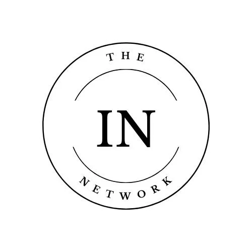 A black and white logo with the words "The IN Network" arranged in a circular design.