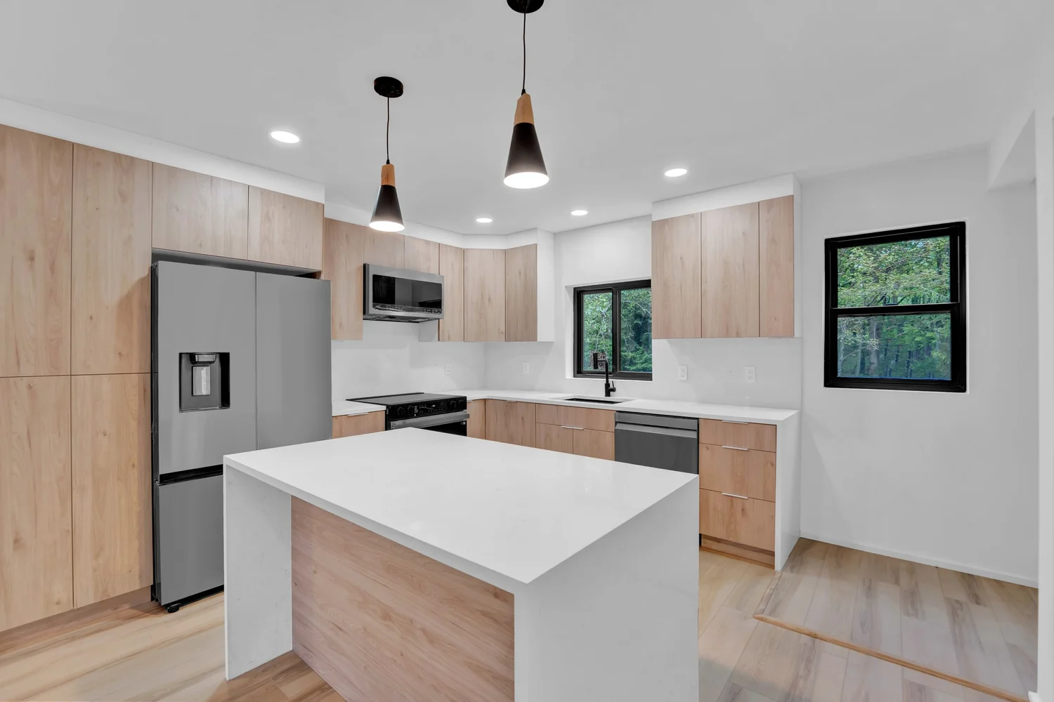 Sleek modern kitchen with island and pendant lighting