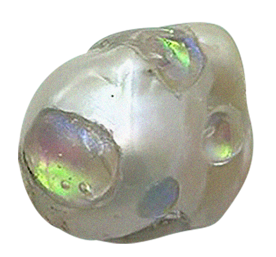 Close-up view of a small, round, white object with iridescent patches, possibly an artificial or decorative item, on a black background.