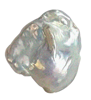 A close-up image of a metallic or mineral stone with a shiny, smooth surface.