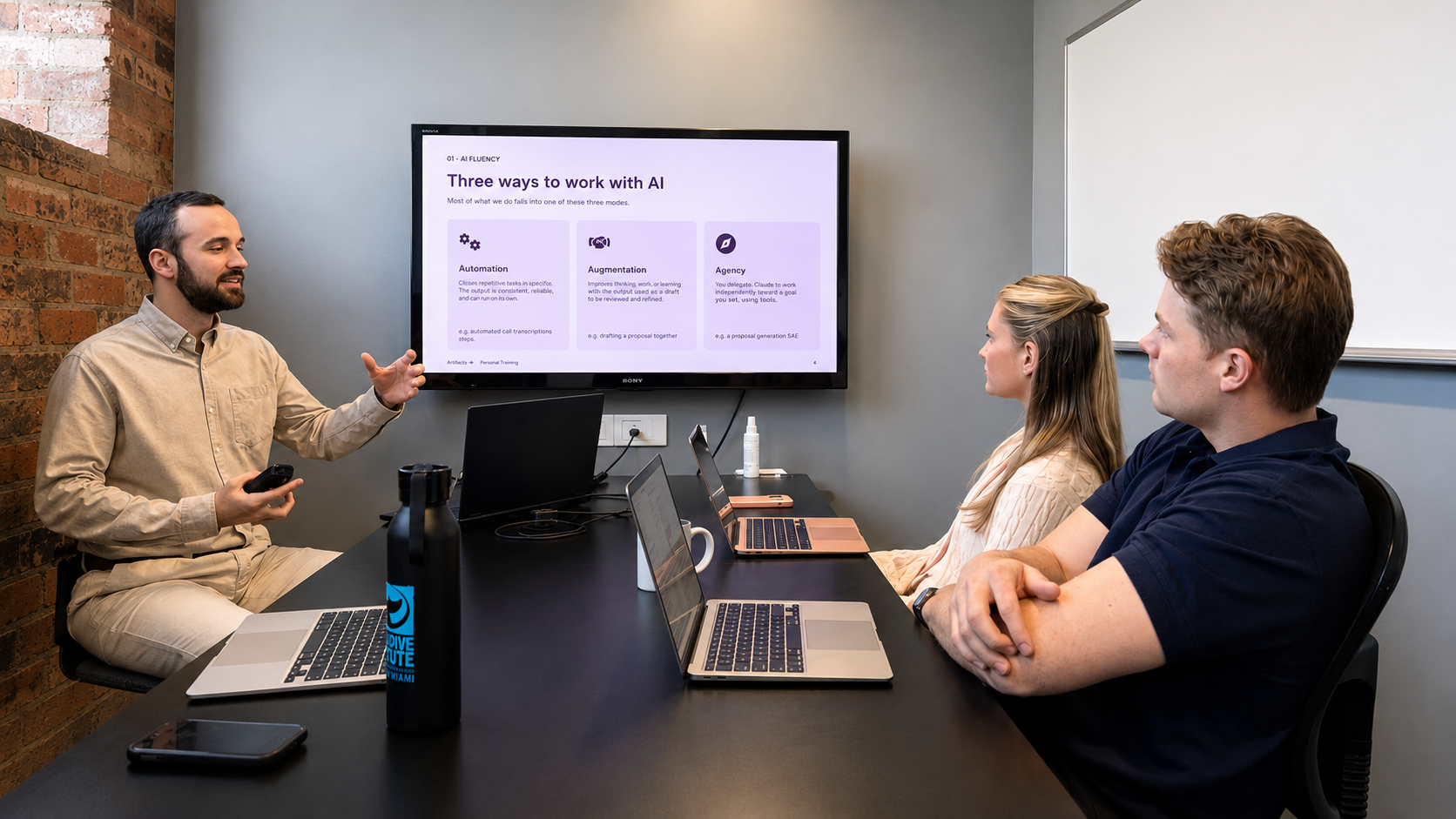 Advancer consultant leading an AI fluency training session with a Brisbane team, presenting three ways to work with AI