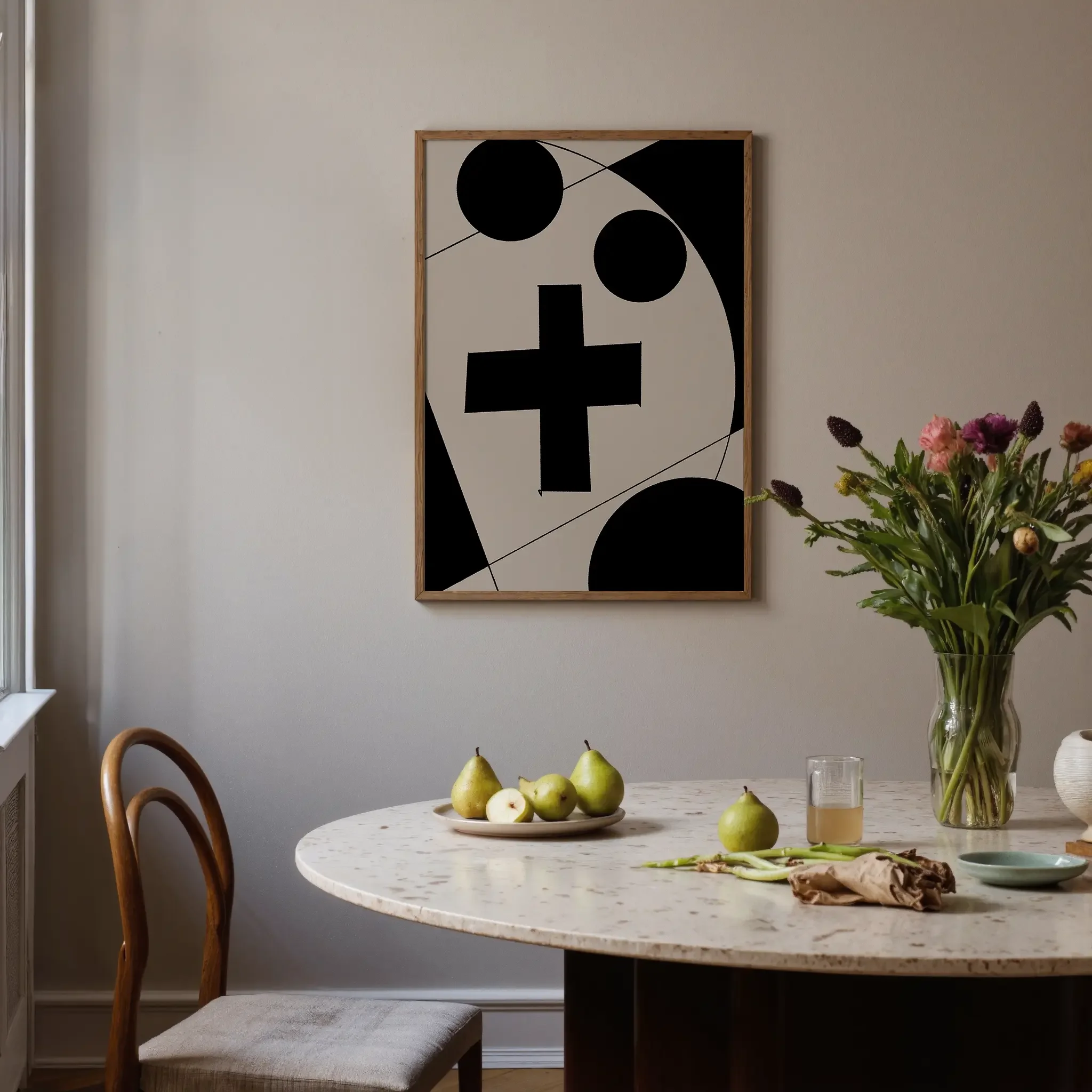 A Christian wall art print featuring cross art poster geometric minimalist design, shown near a window above a round table with flowers.
