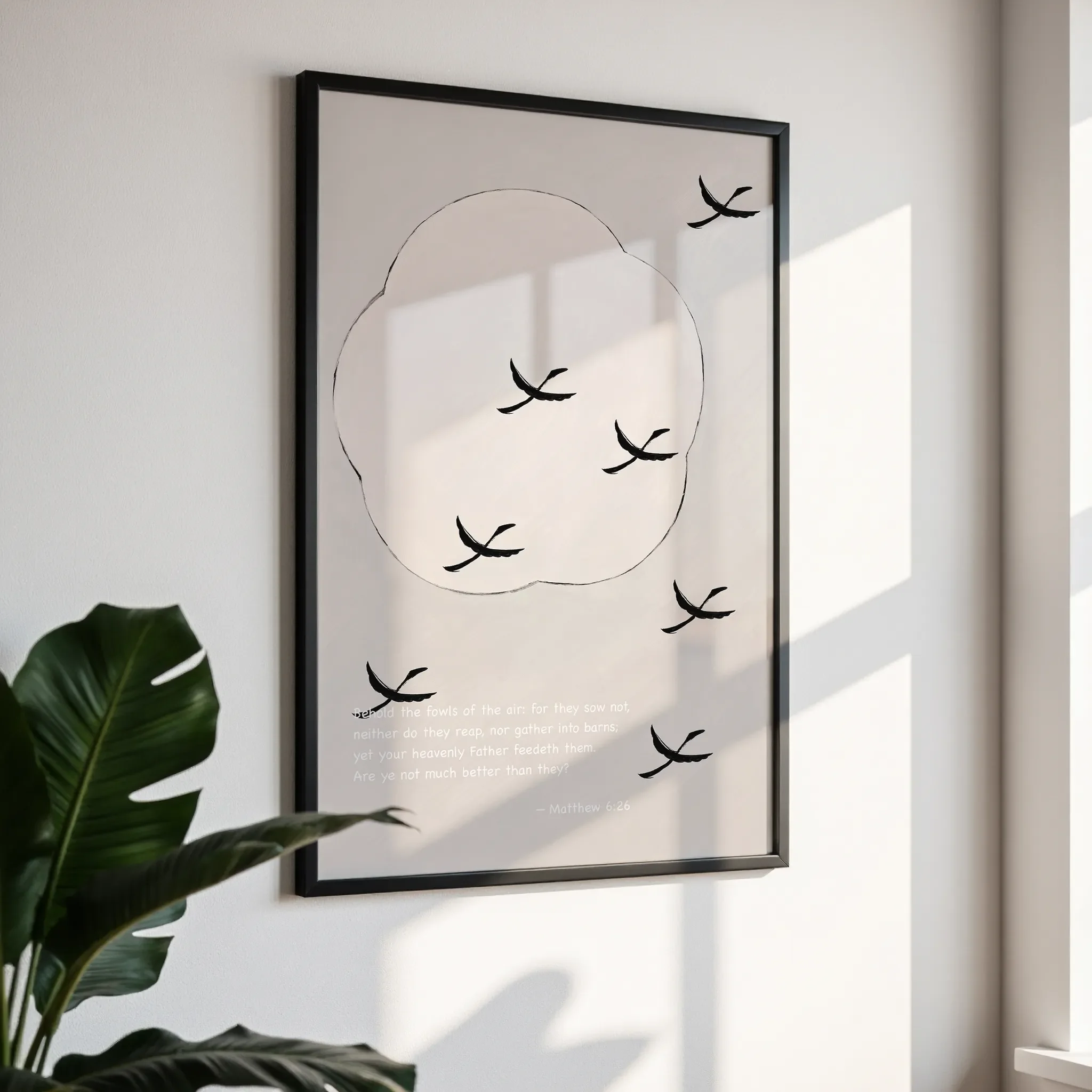 Framed wall art in a simple black frame, photographed from an angled view against a white wall with direct sunlight.