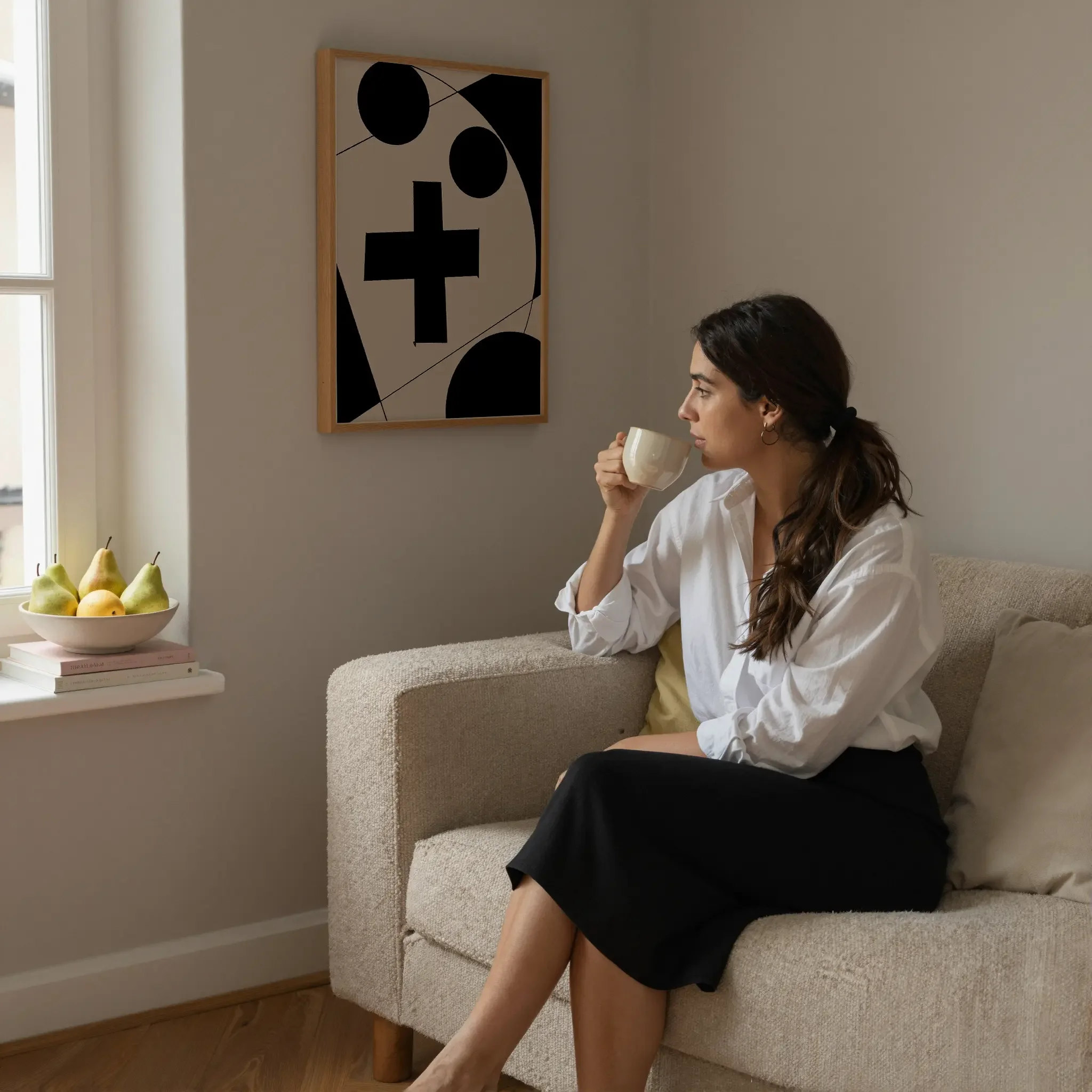A Christian wall art print featuring cross art poster geometric minimalist design, shown in a prayer corner where a person sits on a sofa in quiet reflection.