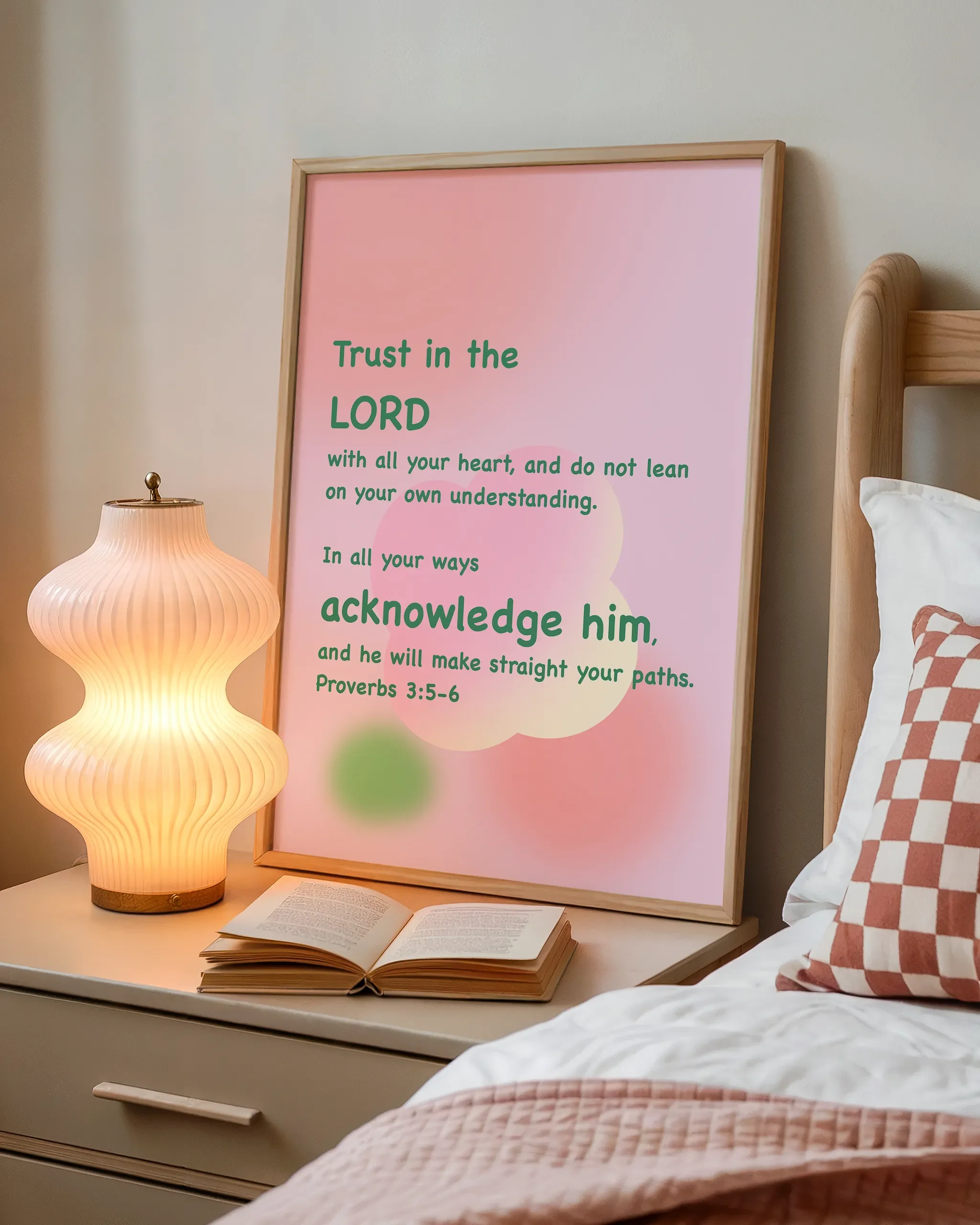 Displayed beside a wooden bed with a book and a softly glowing bedside lamp, creating a cozy atmosphere.
