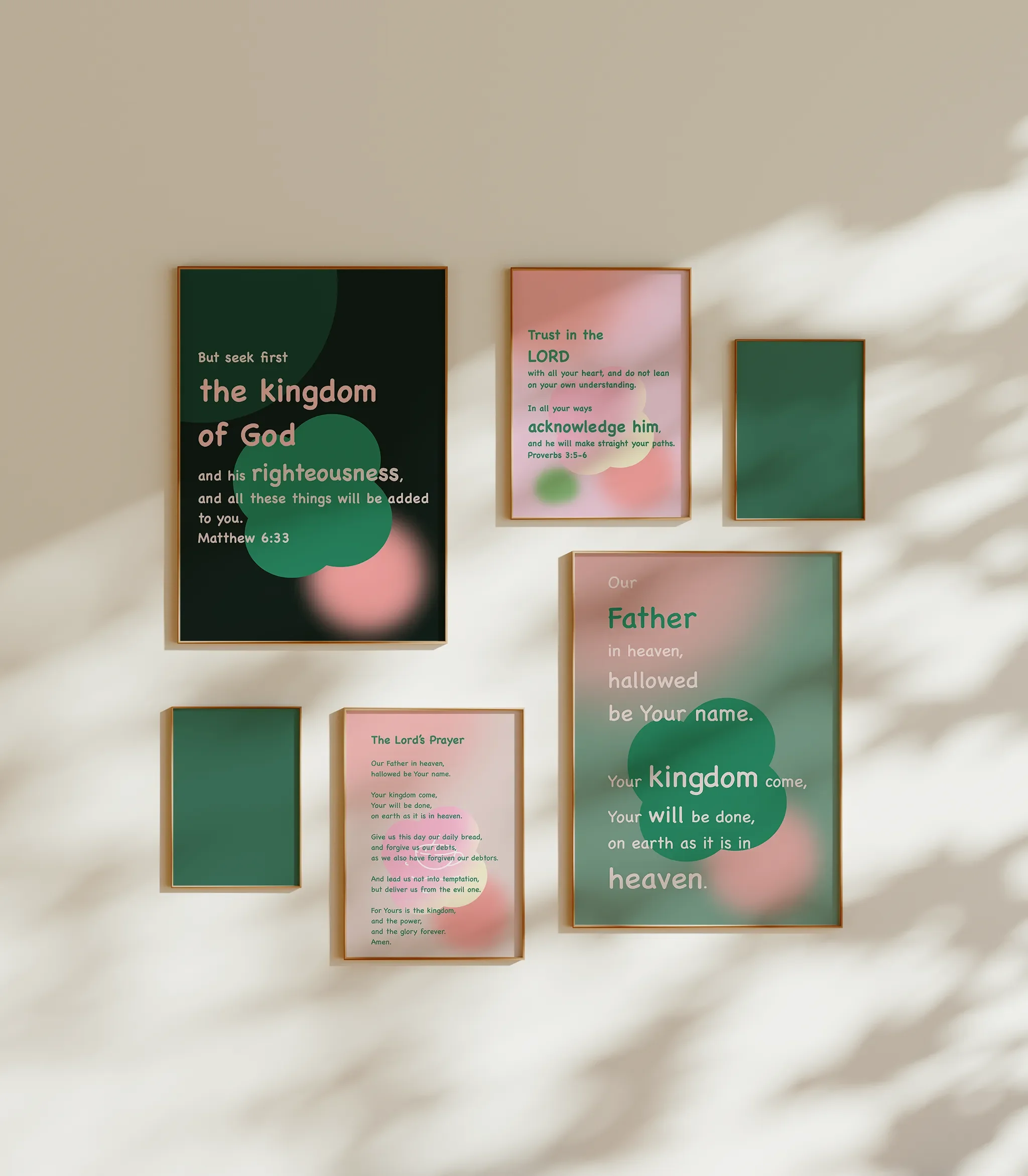 The Lord’s Prayer Collection gallery wall on a white wall with multiple frame sizes, bathed in sunlight.