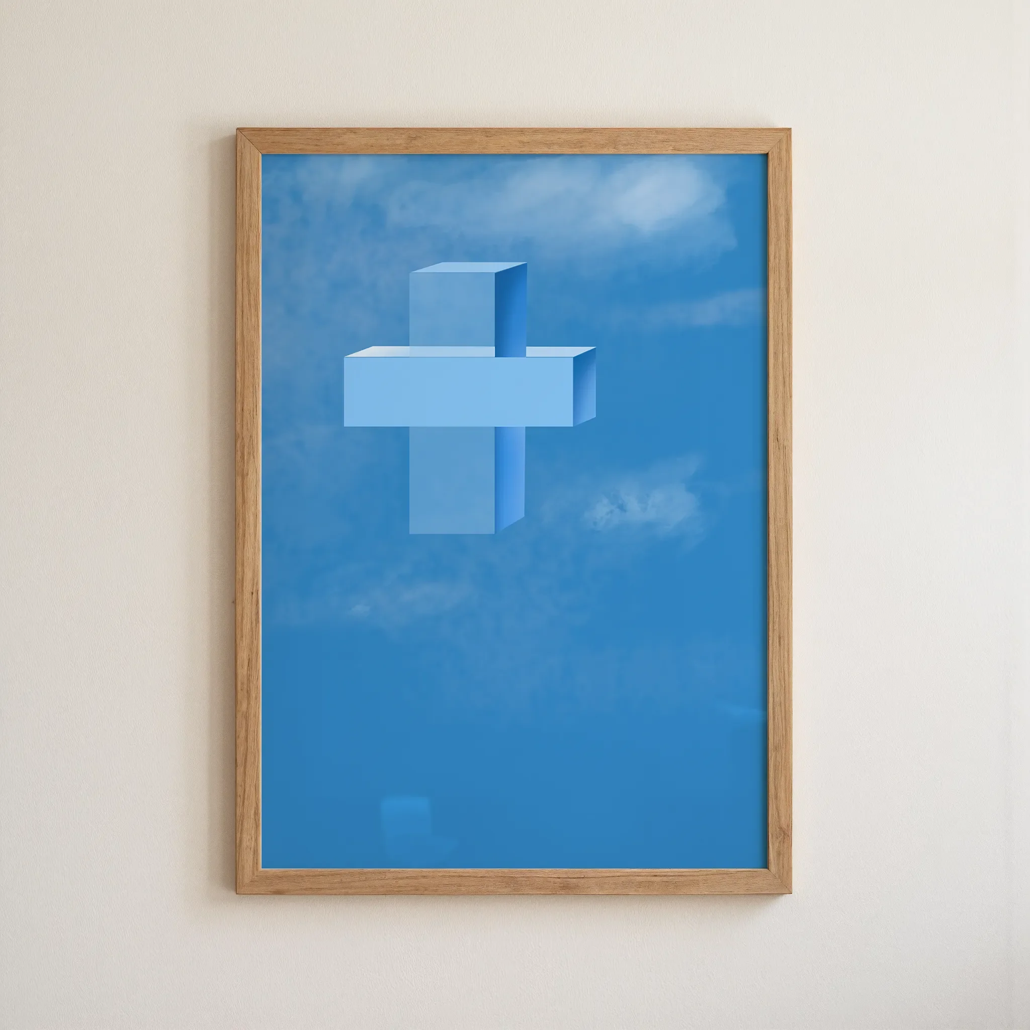 A cross print in a simple wooden frame hangs on a neutral wall.
