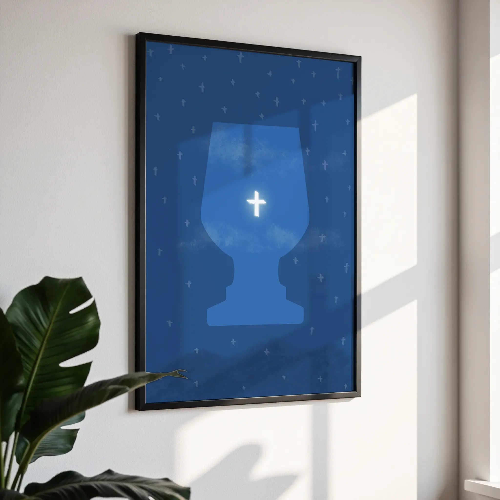 Framed wall art in a simple black frame, photographed from an angled view against a white wall with direct sunlight.